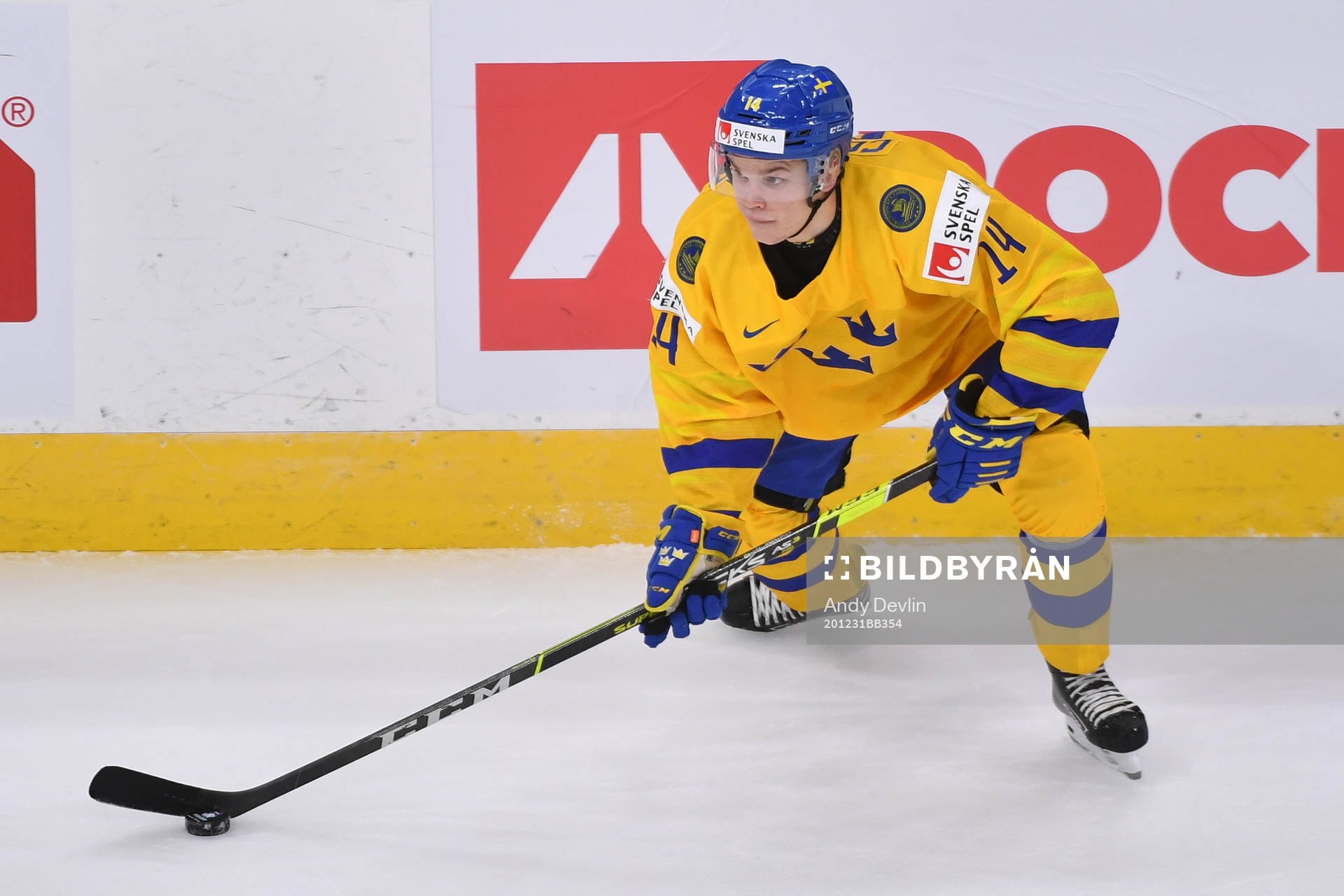 Arvid Costmar of Sweden skates with the puck