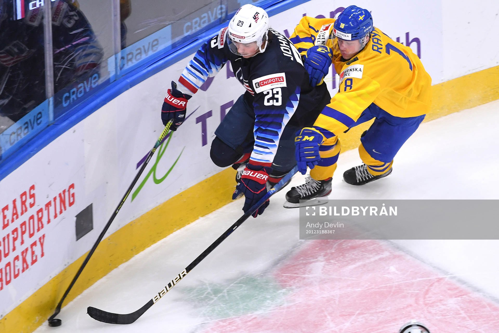 Ryan Johnson of USA skates with the puck while Lucas
