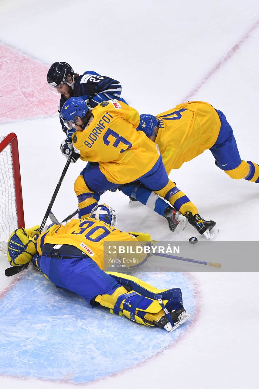 Hugo Alnefelt of Sweden makes a save as teammates Tobias