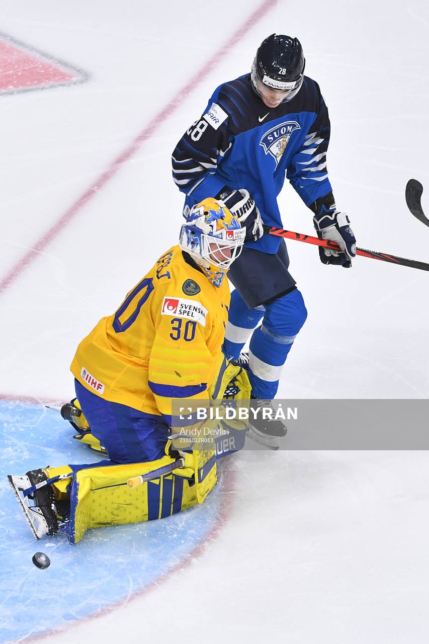 Hugo Alnefelt of Sweden makes a save with Henri Nikkanen of