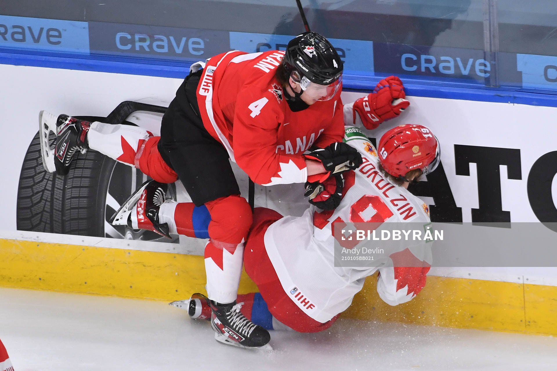 Bowen Byram of Canada knocks Vasili Podkolzin of Russia to