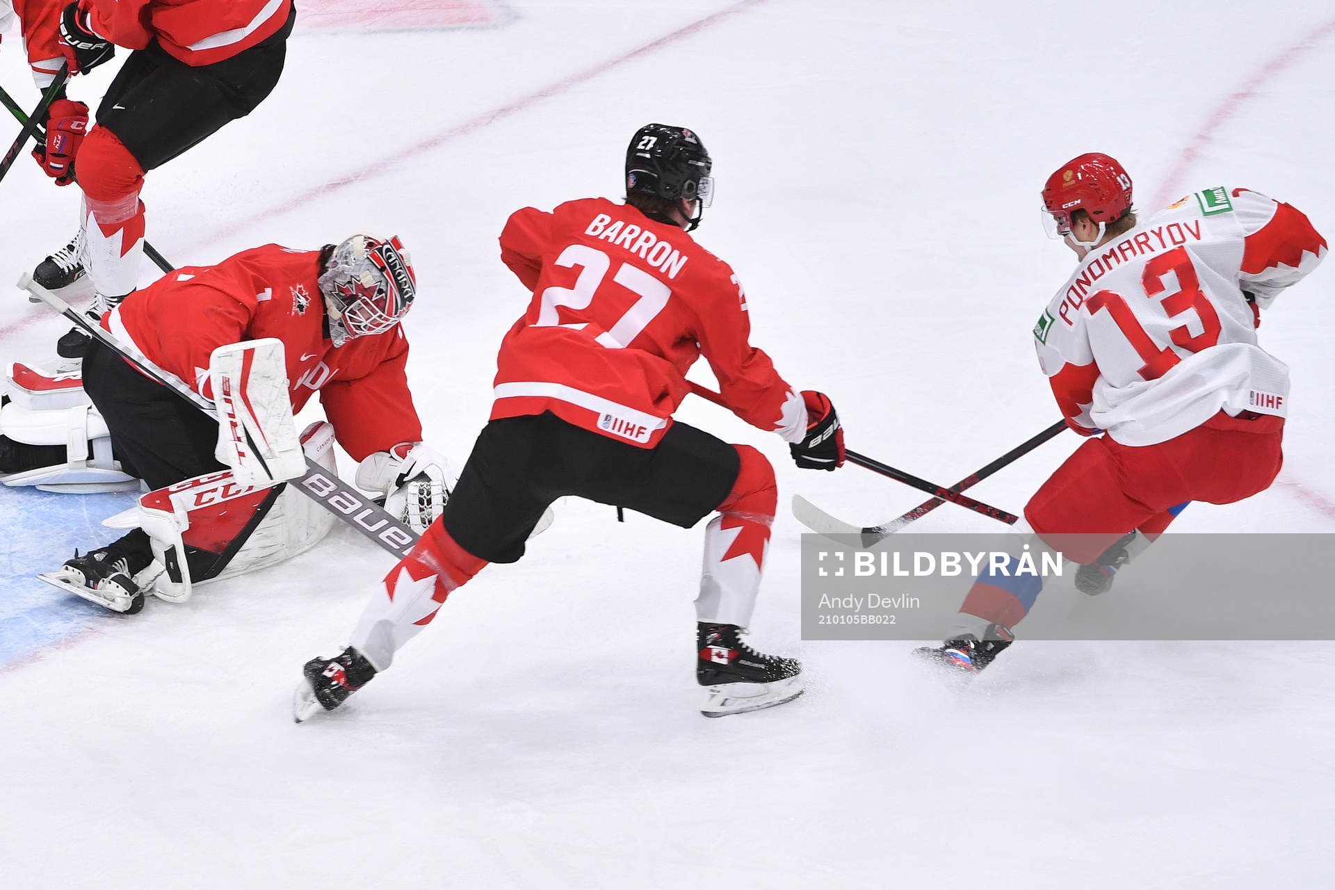 Devon Levi of Canada makes a save with Vasili Ponomaryov of