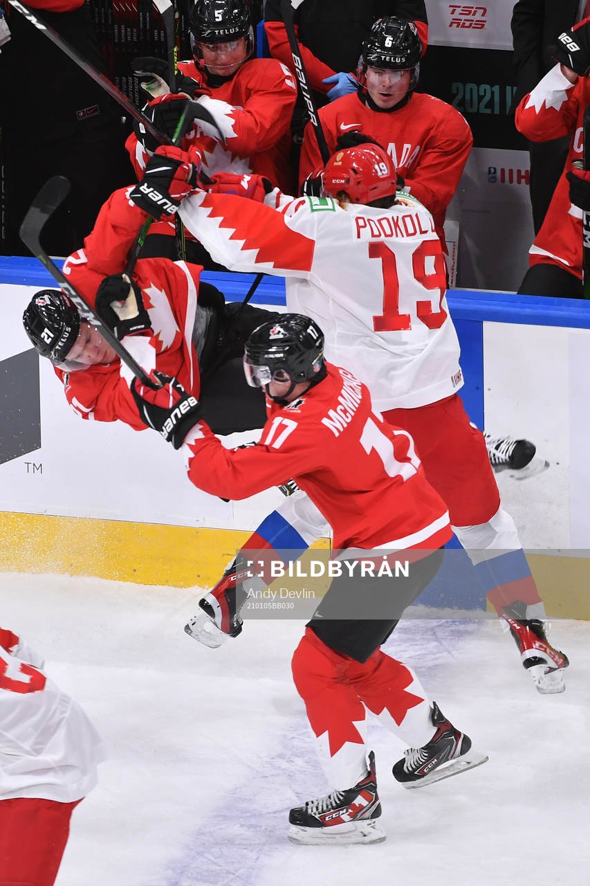 Vasili Podkolzin of Russia hits Kaiden Guhle of Canada