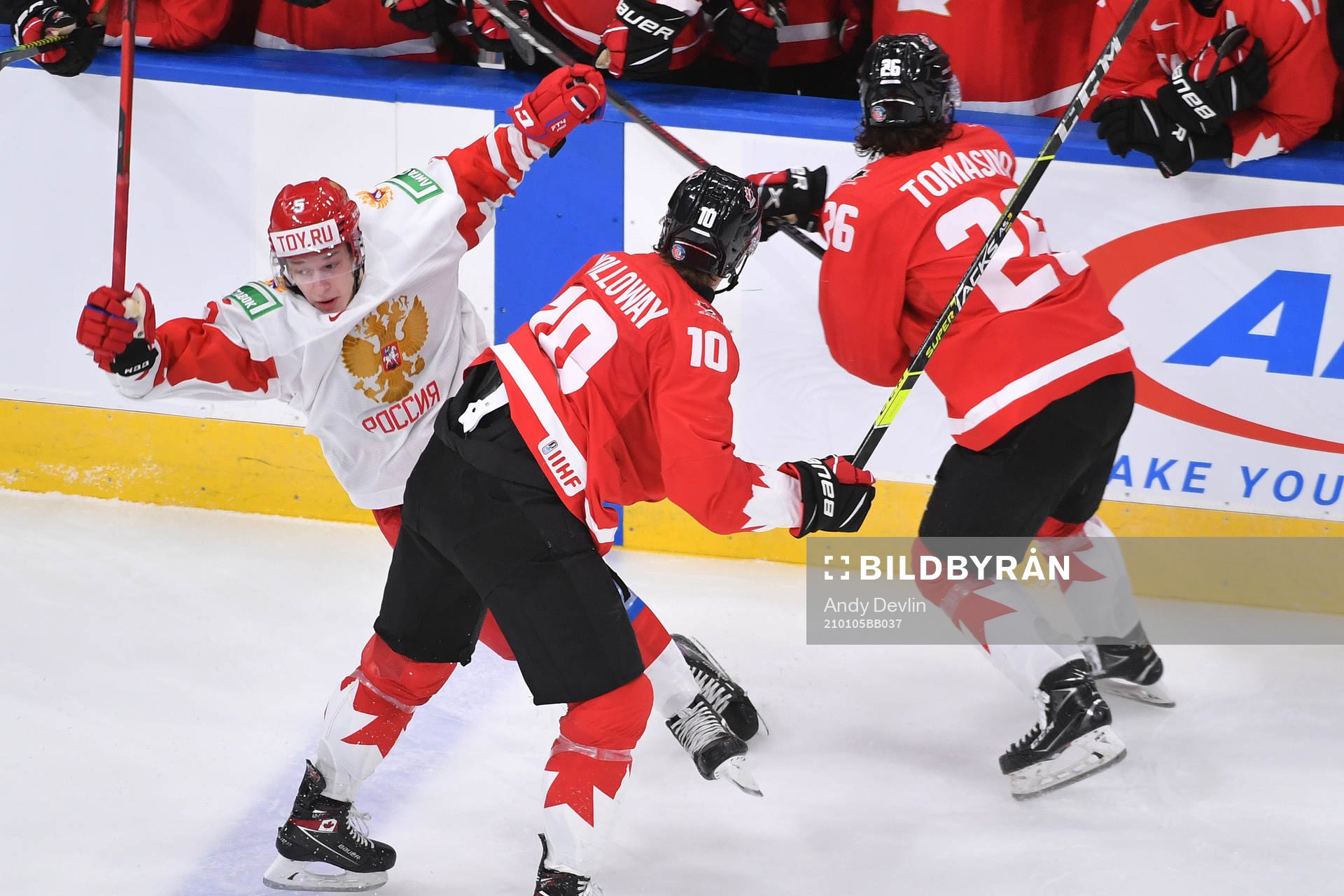 Philip Tomasino of Canada collides with Danil Chaika of