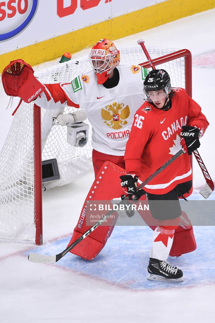 Philip Tomasino of Canada gets his skate caught in the pad