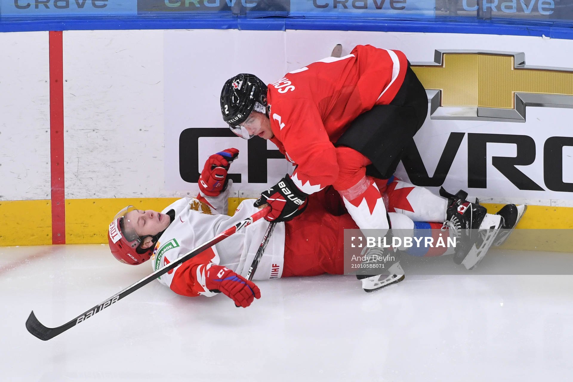 Braden Schneider of Canada checks Mikhail Abramov of Russia