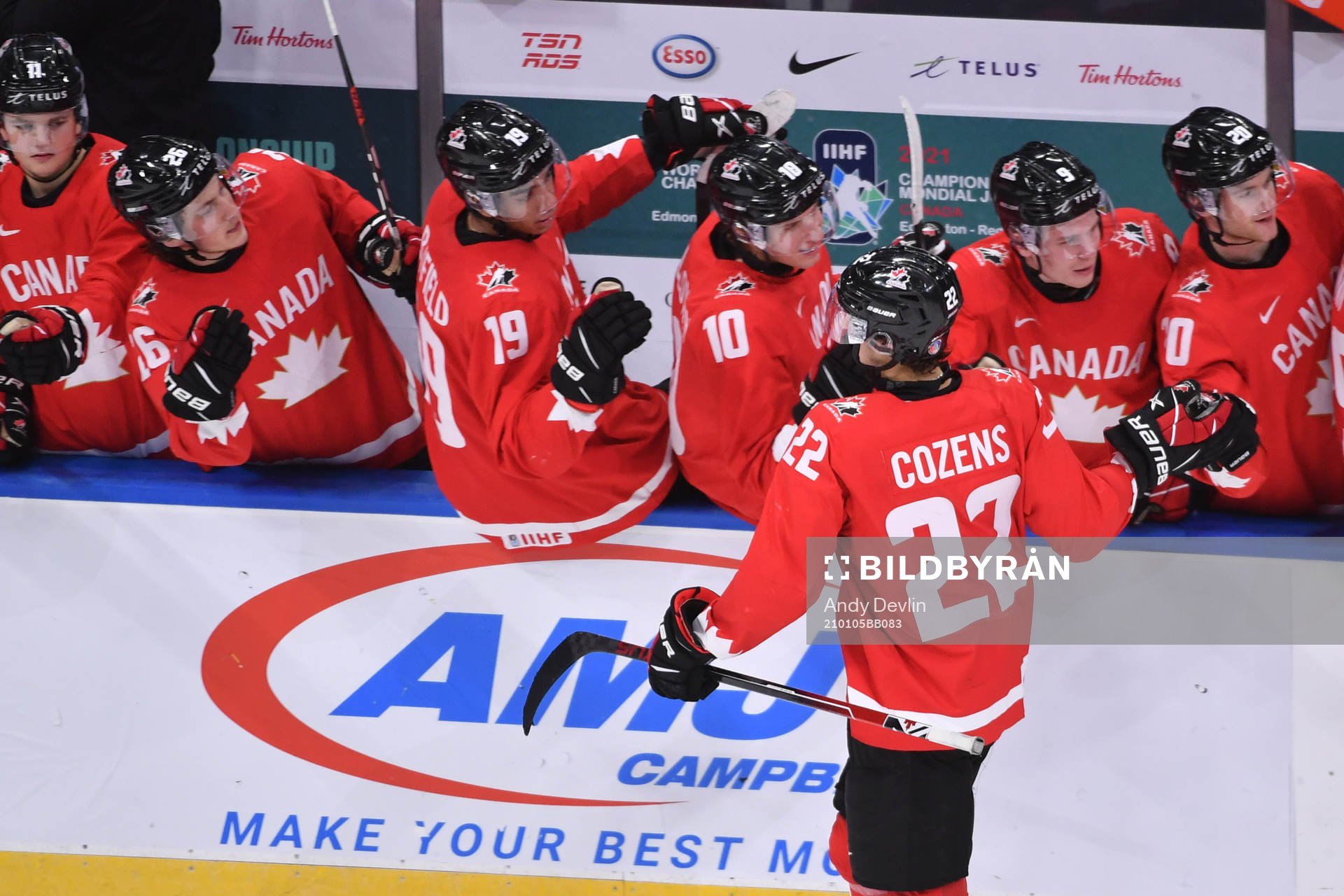 Dylan Cozens of Canada celebrates at the bench