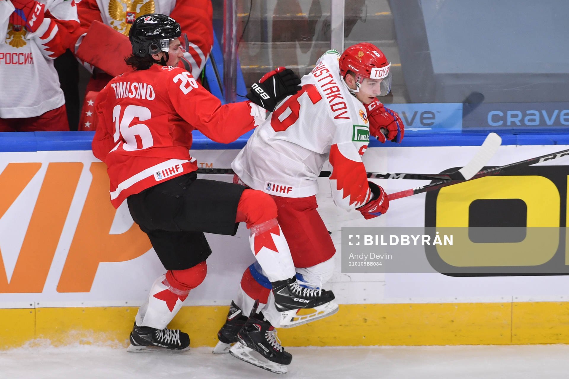 Philip Tomasino of Canada collides with Semyon Chistyakov