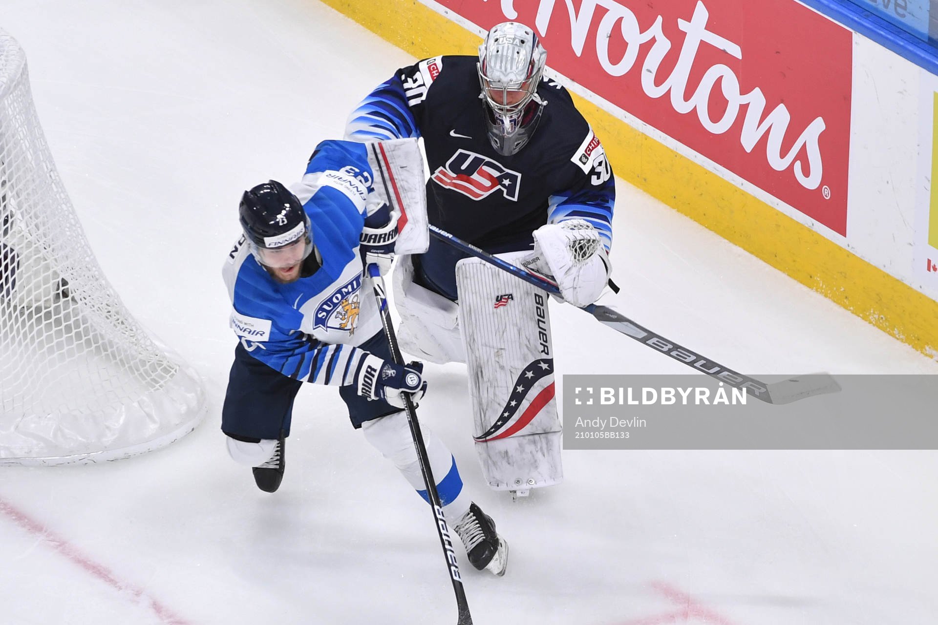 Mikko Petman of Finland collides with Spencer Knight of USA