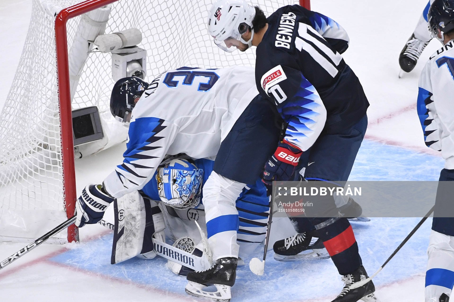 Kari Piiroinen of Finland smothers the puck as teammate