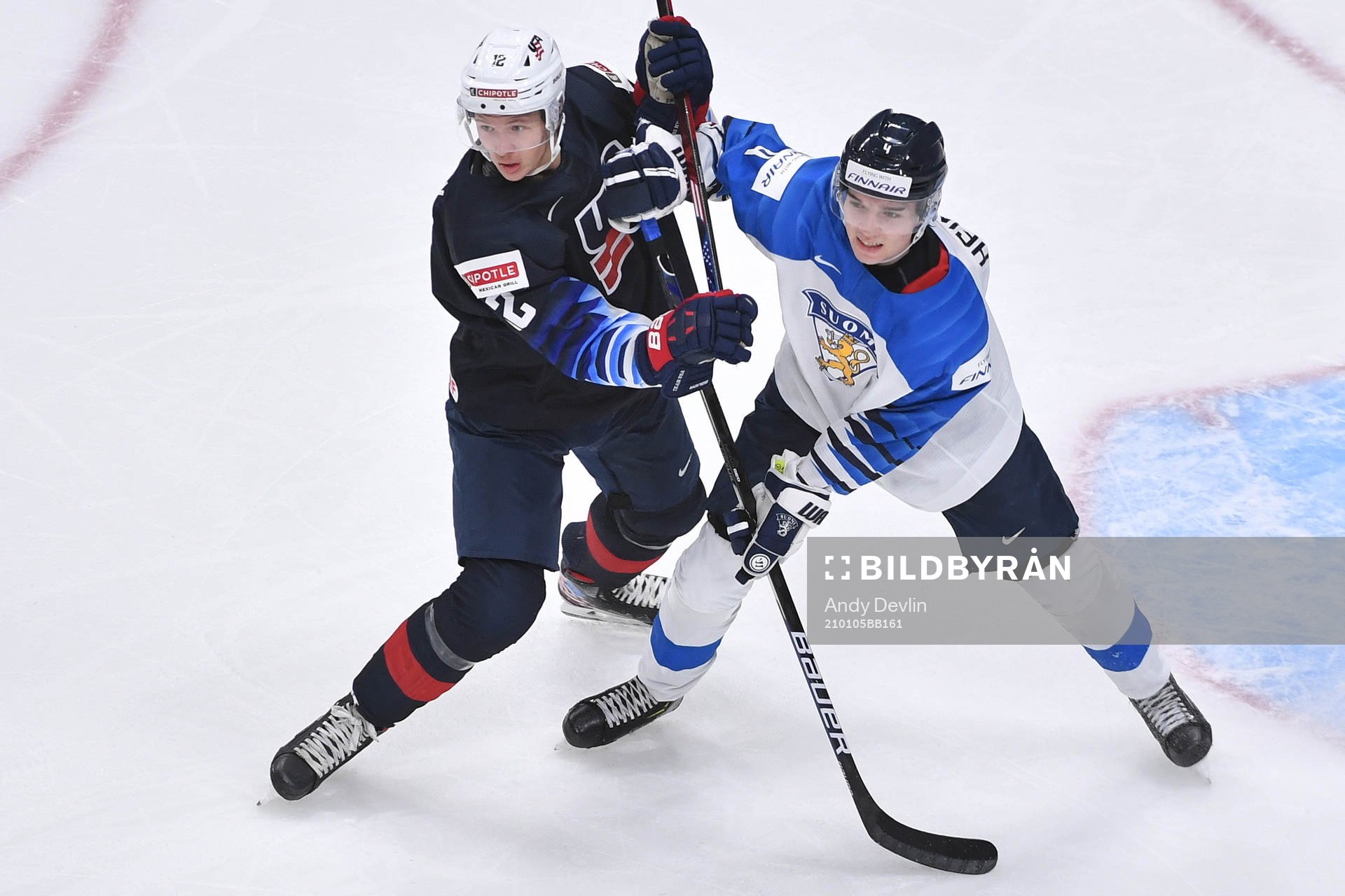 Matthew Boldy of USA and Ville Heinola of Finland battle