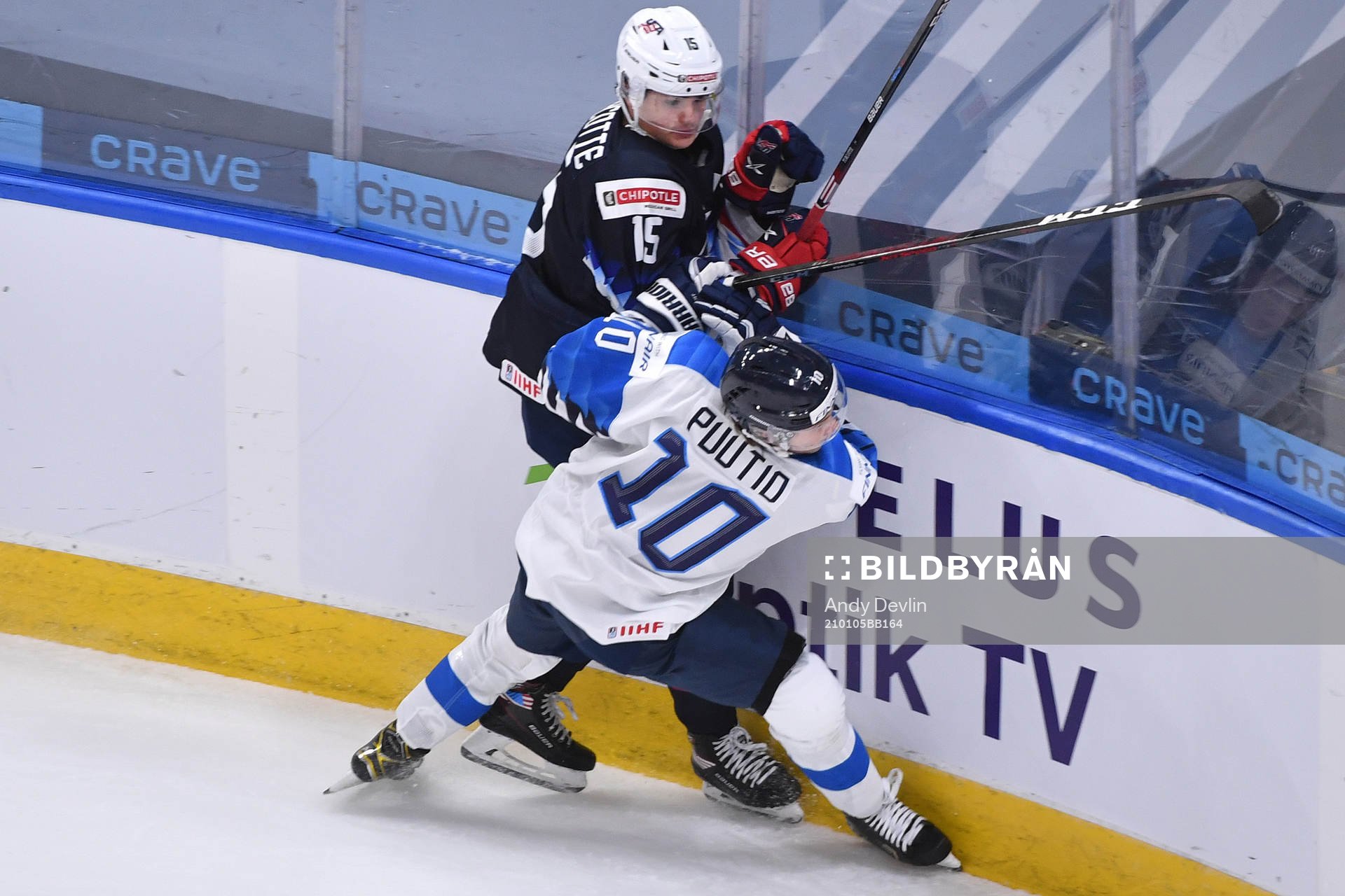 Kasper Puutio of Finland collides with Alex Turcotte of USA