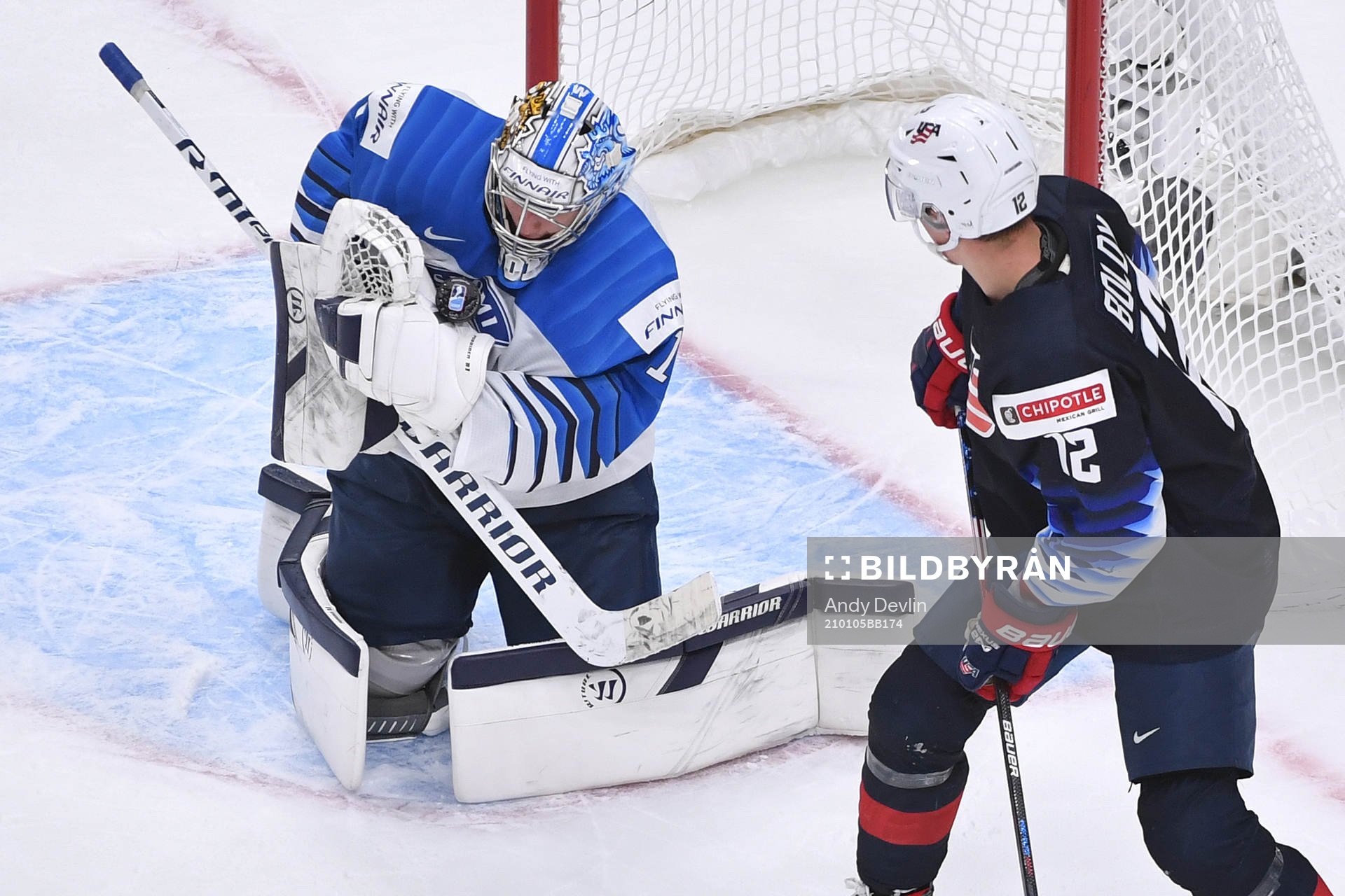 Kari Piiroinen of Finland makes a save with Matthew Boldy