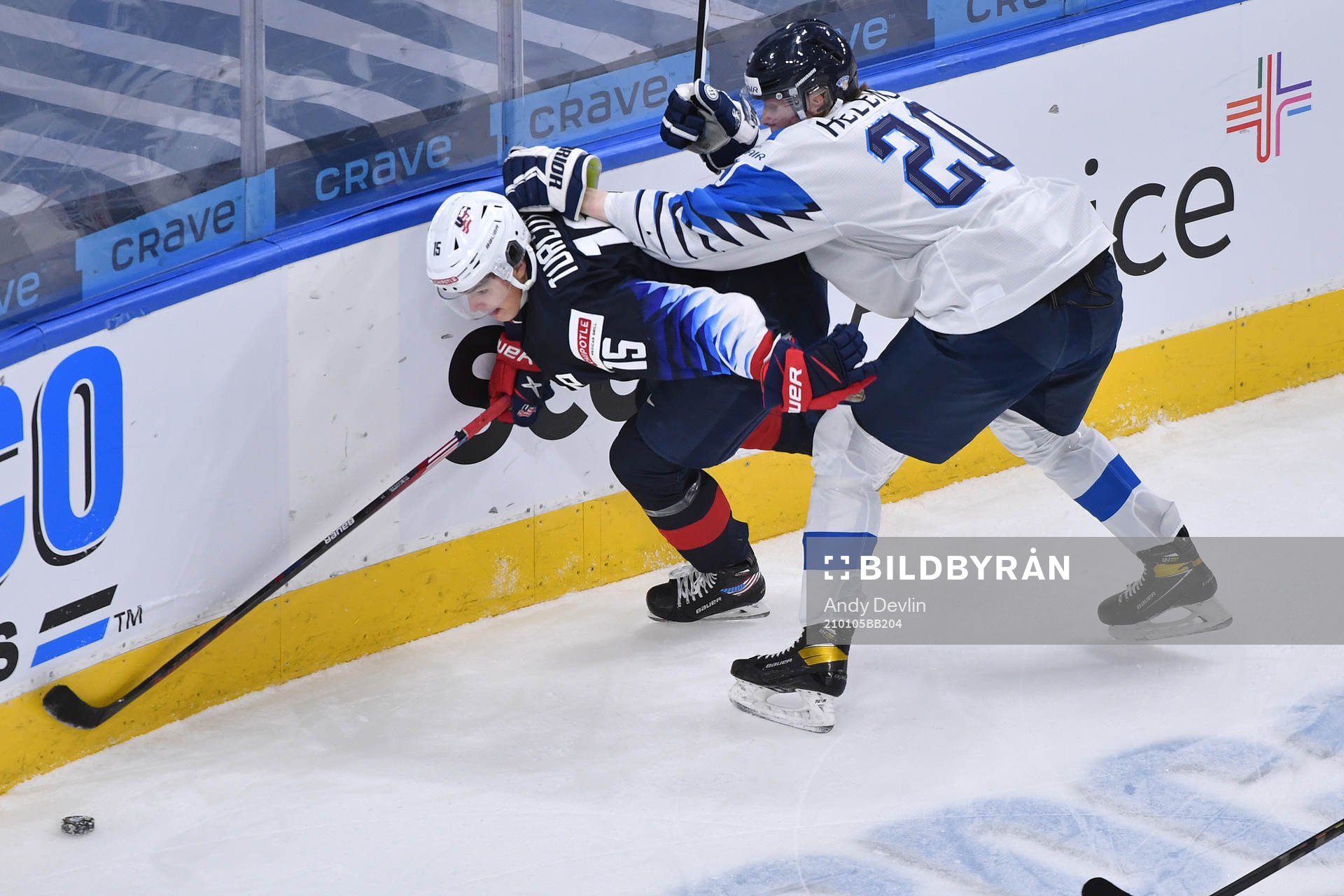 Samuel Helenius of Finland collides with Alex Turcotte of