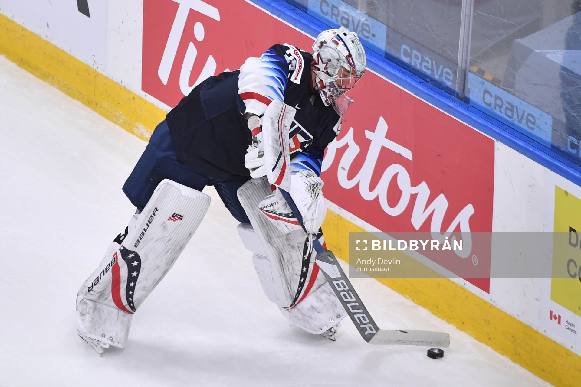 Spencer Knight of USA handles the puck