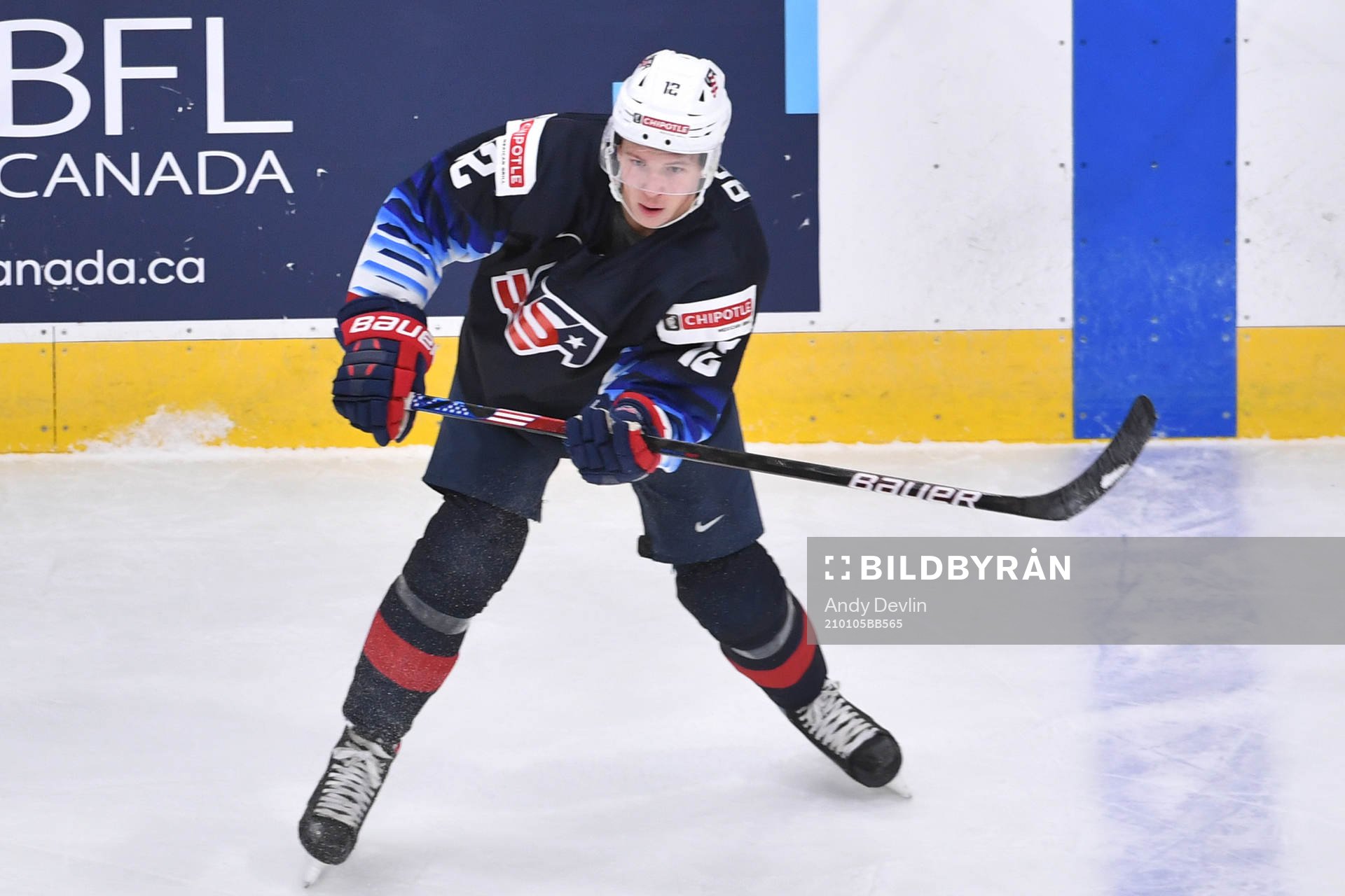 Matthew Boldy of USA passes the puck