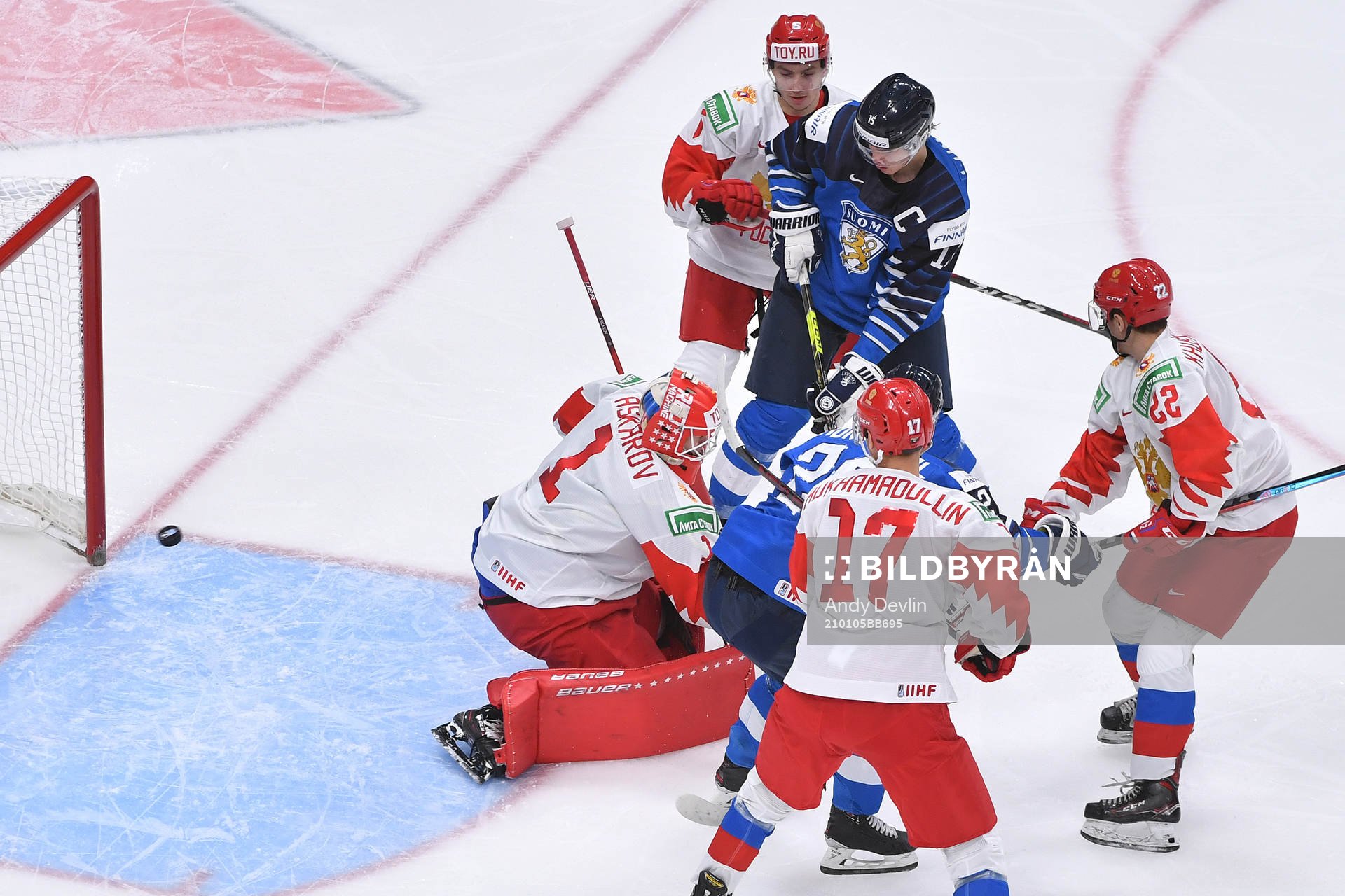 Anton Lundell of Finland fends of Semyon Chistyakov, Shakir