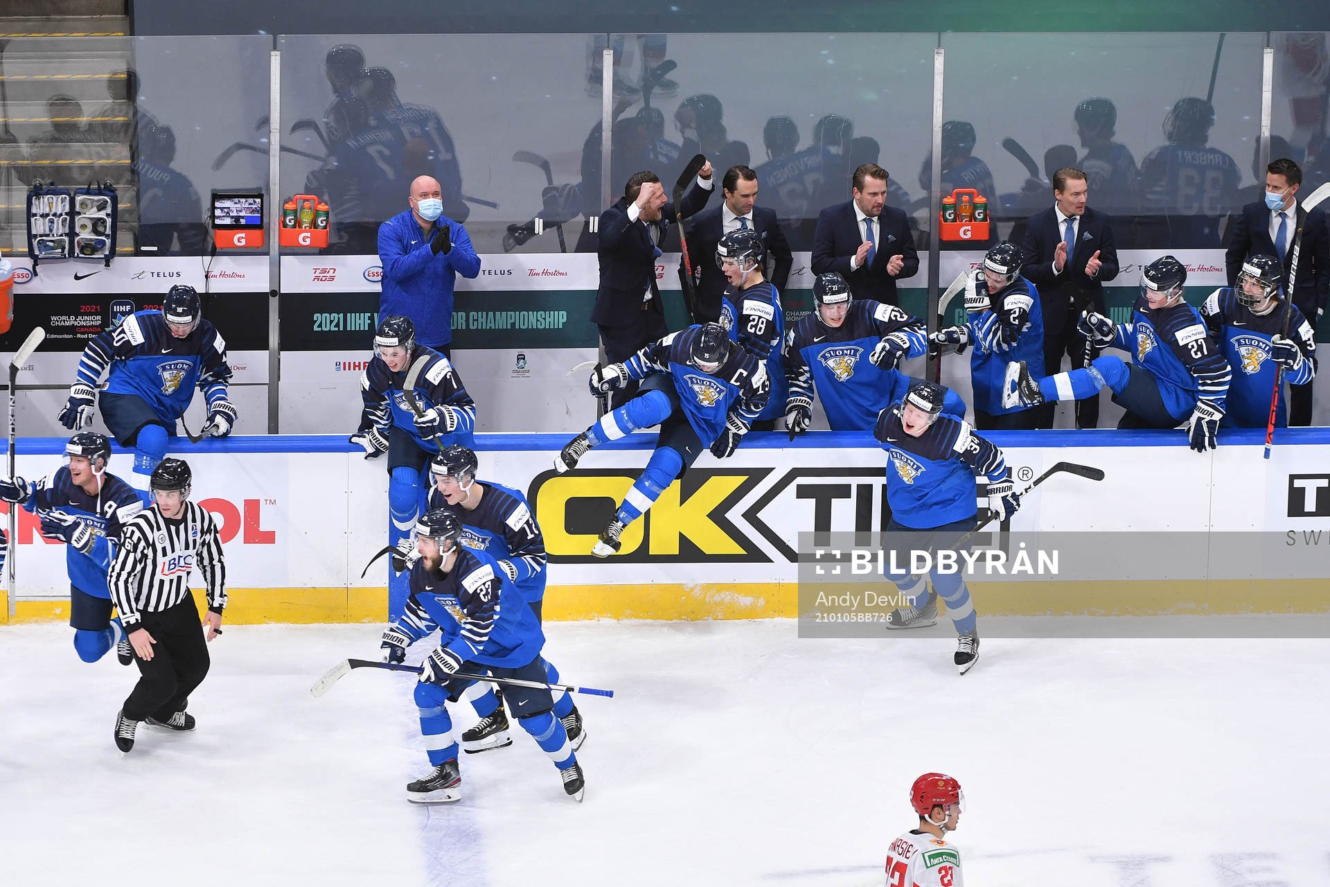 Team Finland jumps over the boards to celebrate their