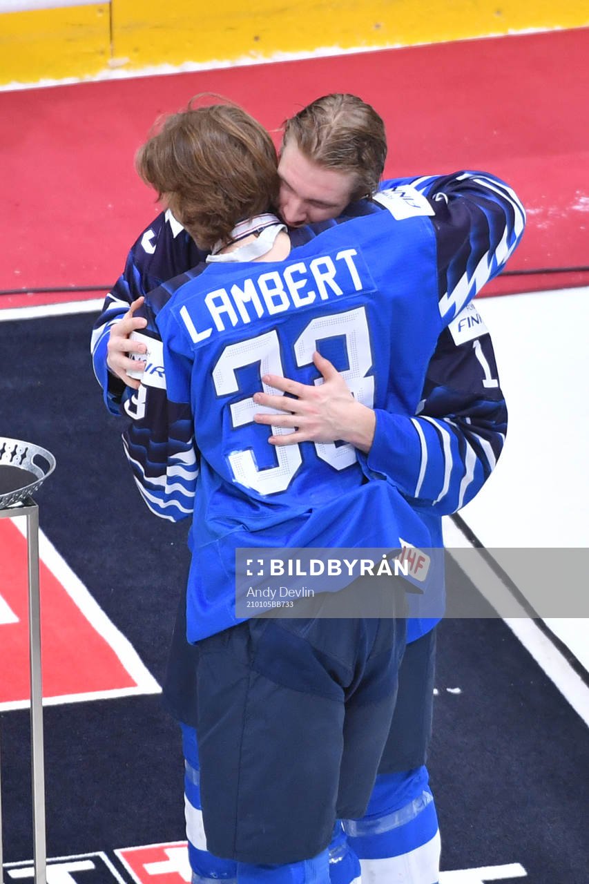 Team captain Anton Lundell of Finland hugs teammate Brad