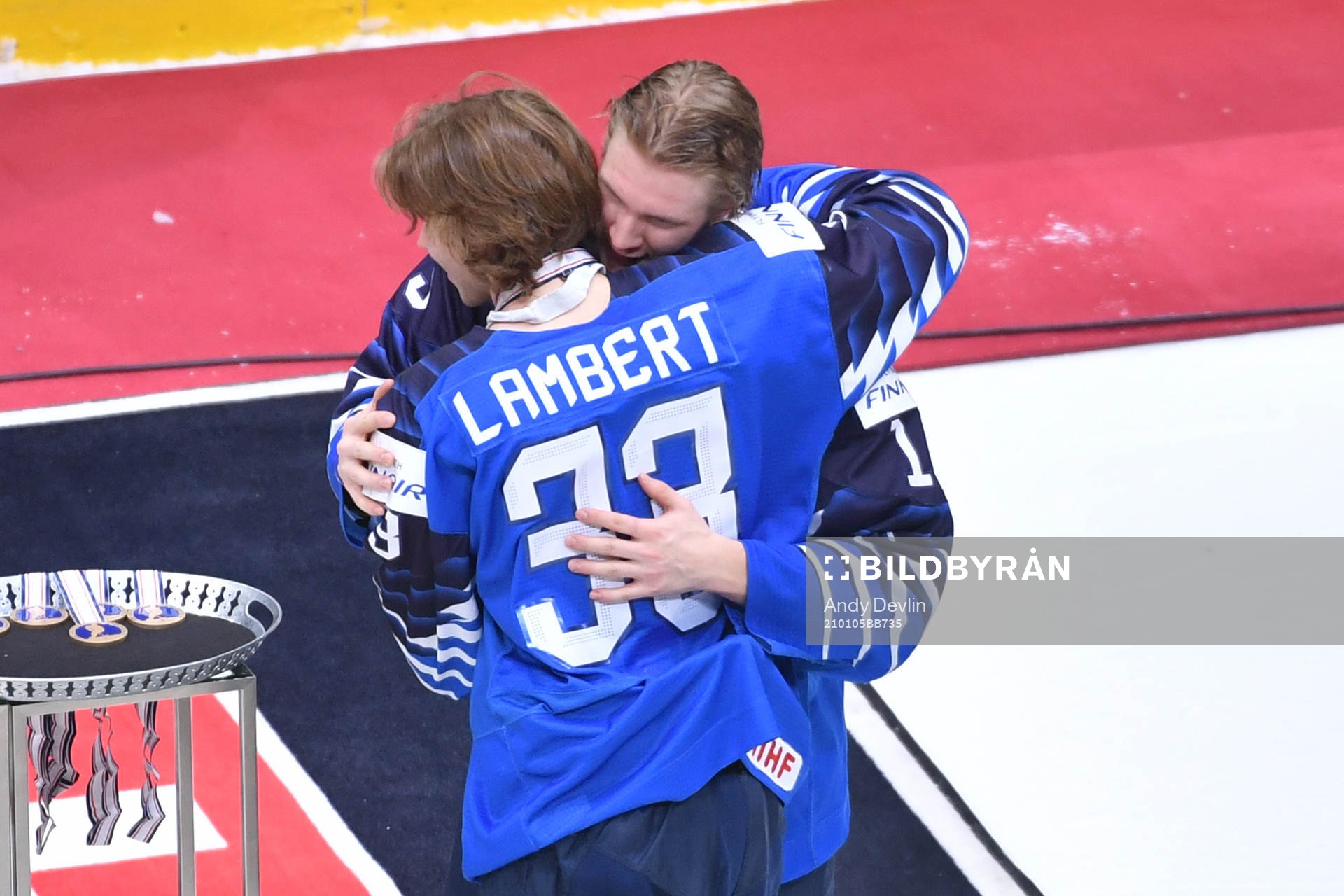 Team captain Anton Lundell of Finland hugs teammate Brad