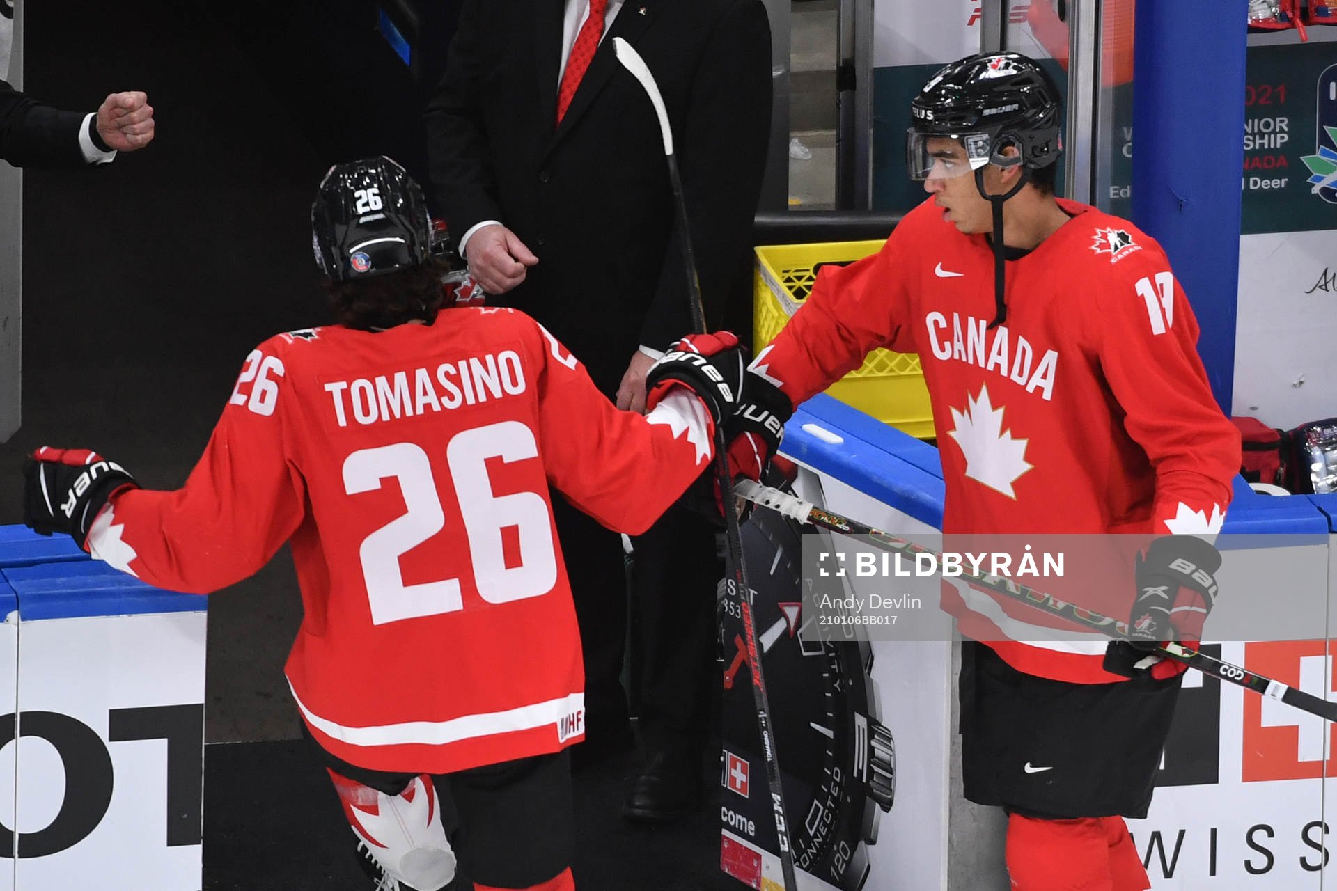 Quinton Byfield and Philip Tomasino of Canada fist bump as
