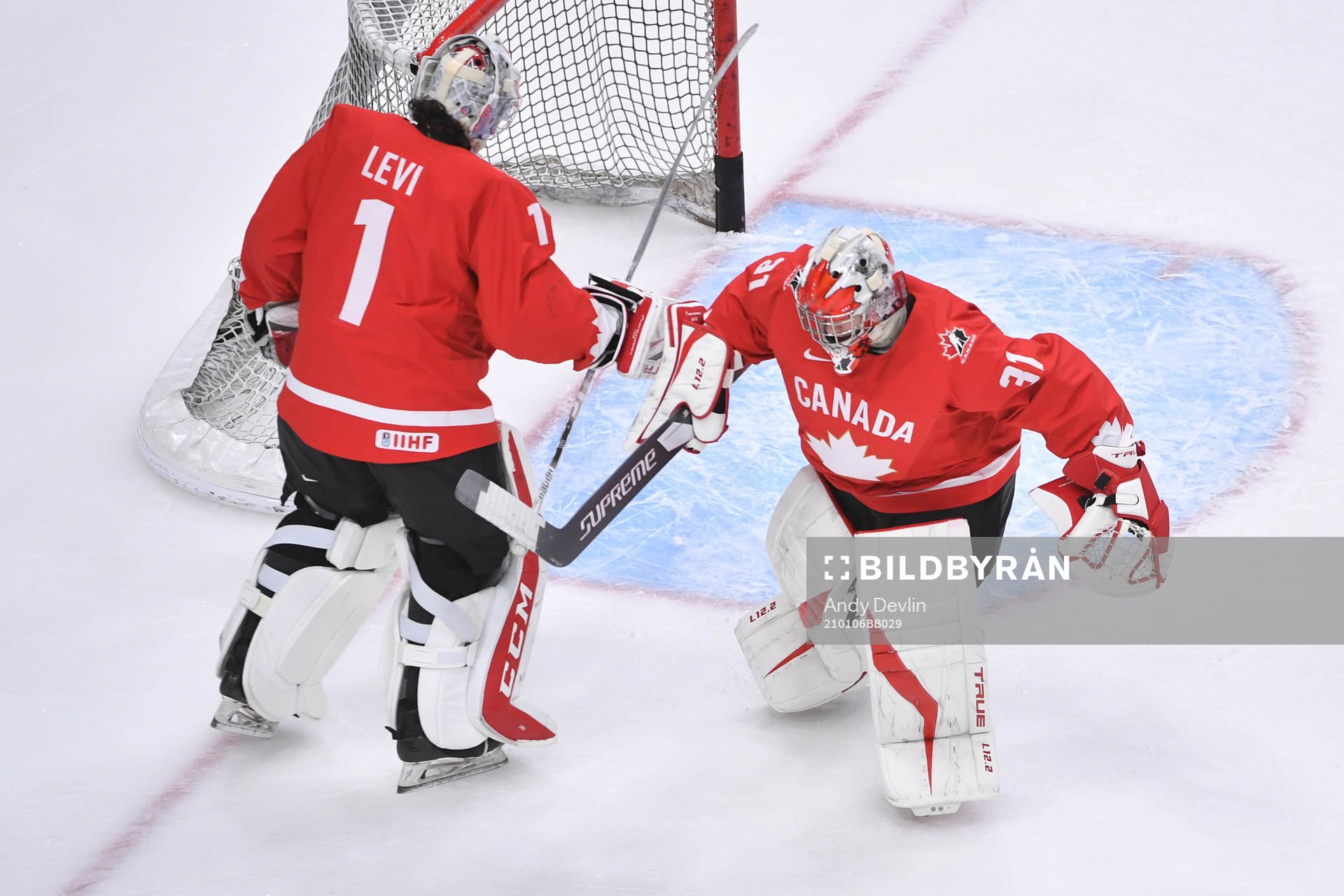 Dylan Garand and Devon Levi of Canada exchange spots