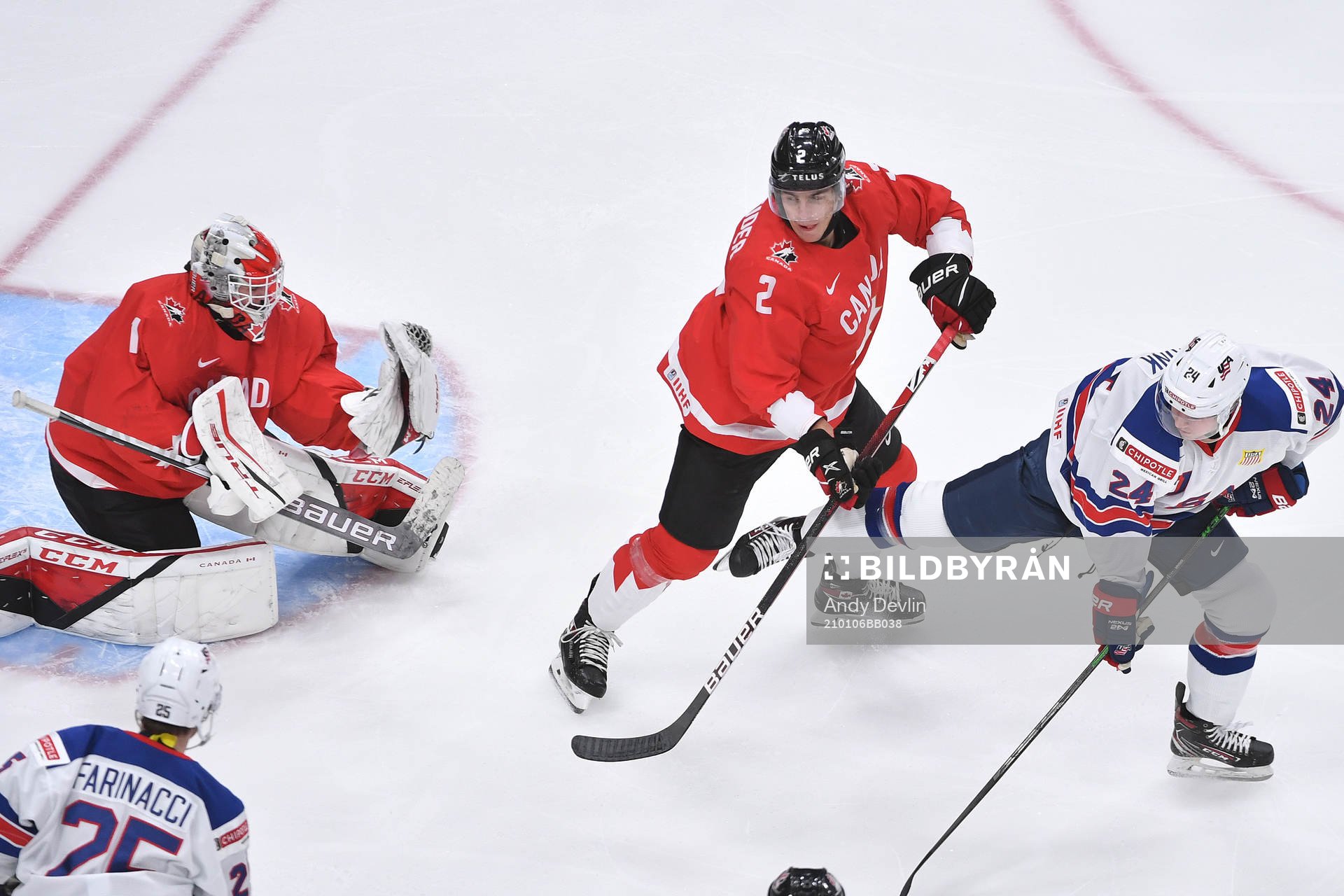 Devon Levi of Canada makes a save off a deflection from