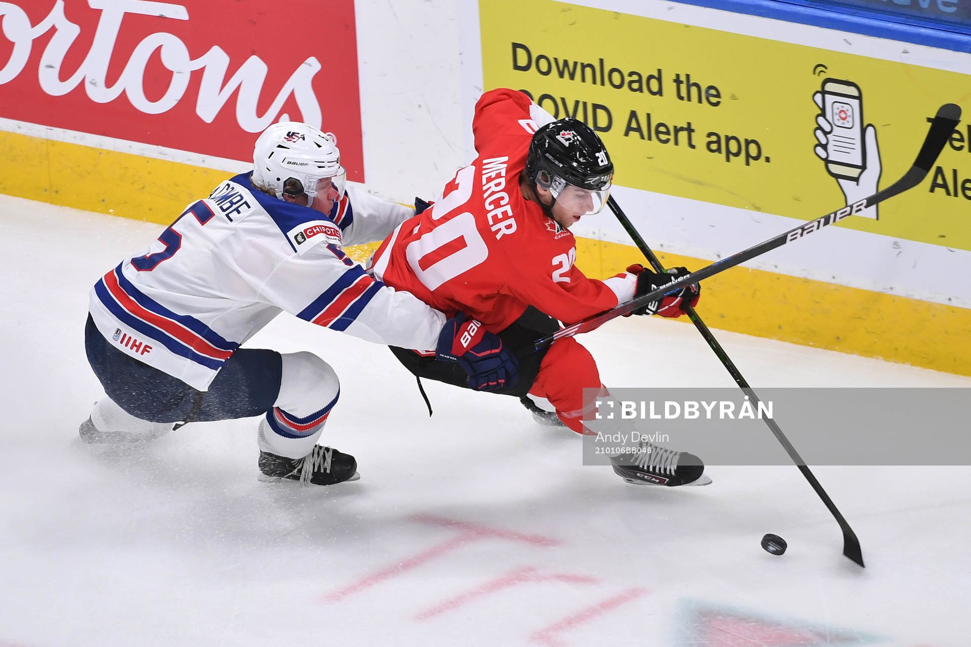 Dawson Mercer of Canada protects the puck from Jackson