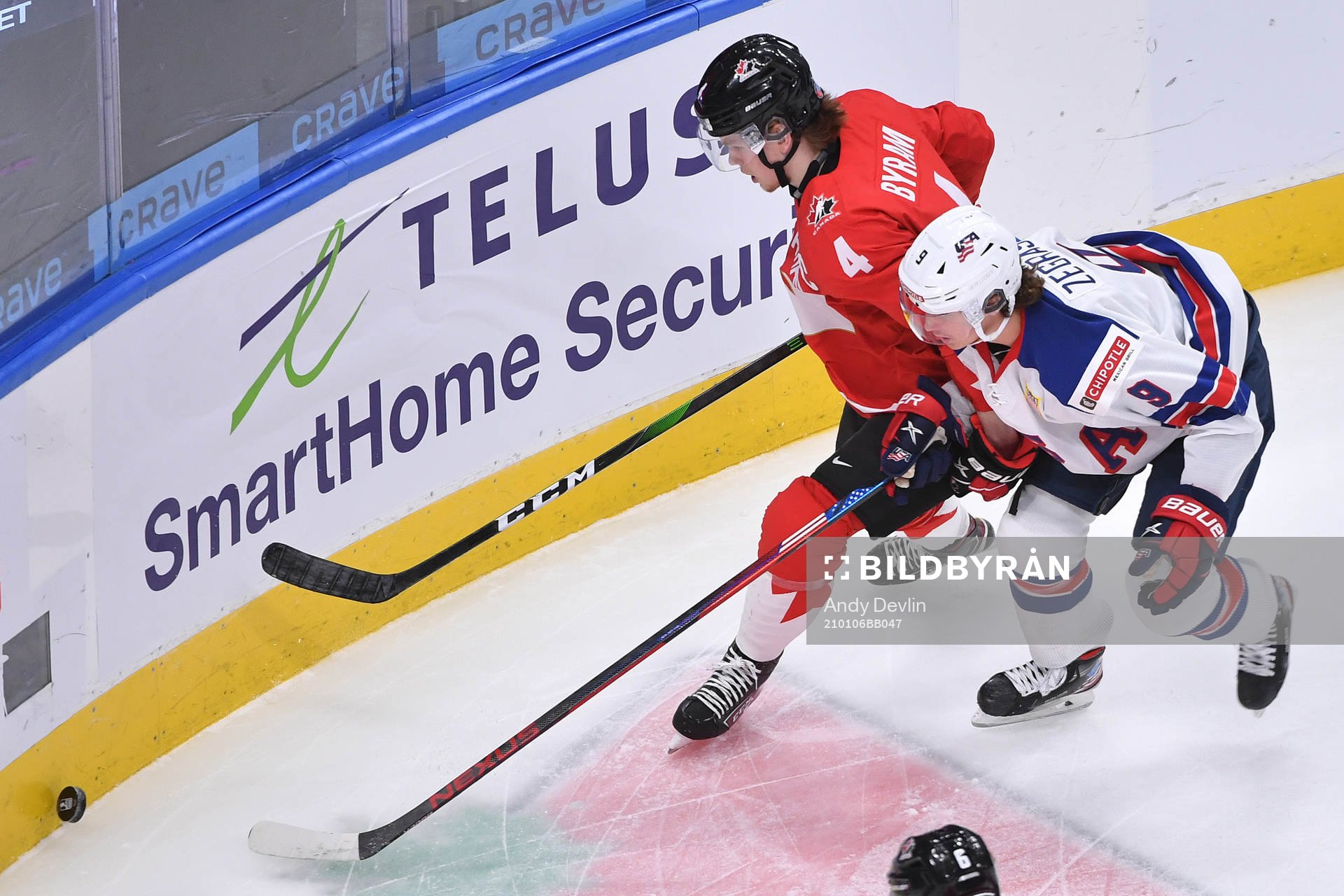 Bowen Byram of Canada protects the puck from Trevor Zegras