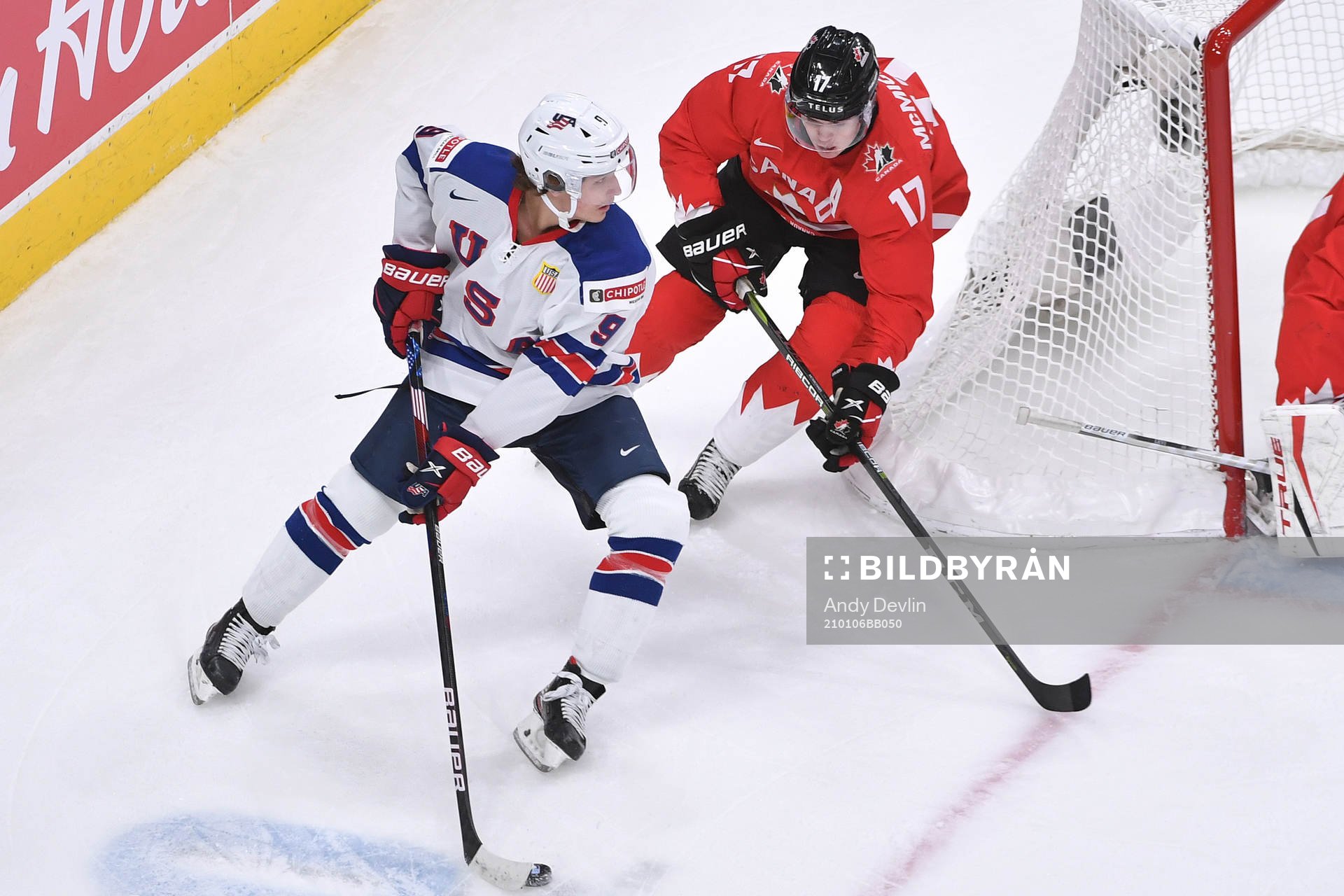 Trevor Zegras of USA protects the puck from Connor
