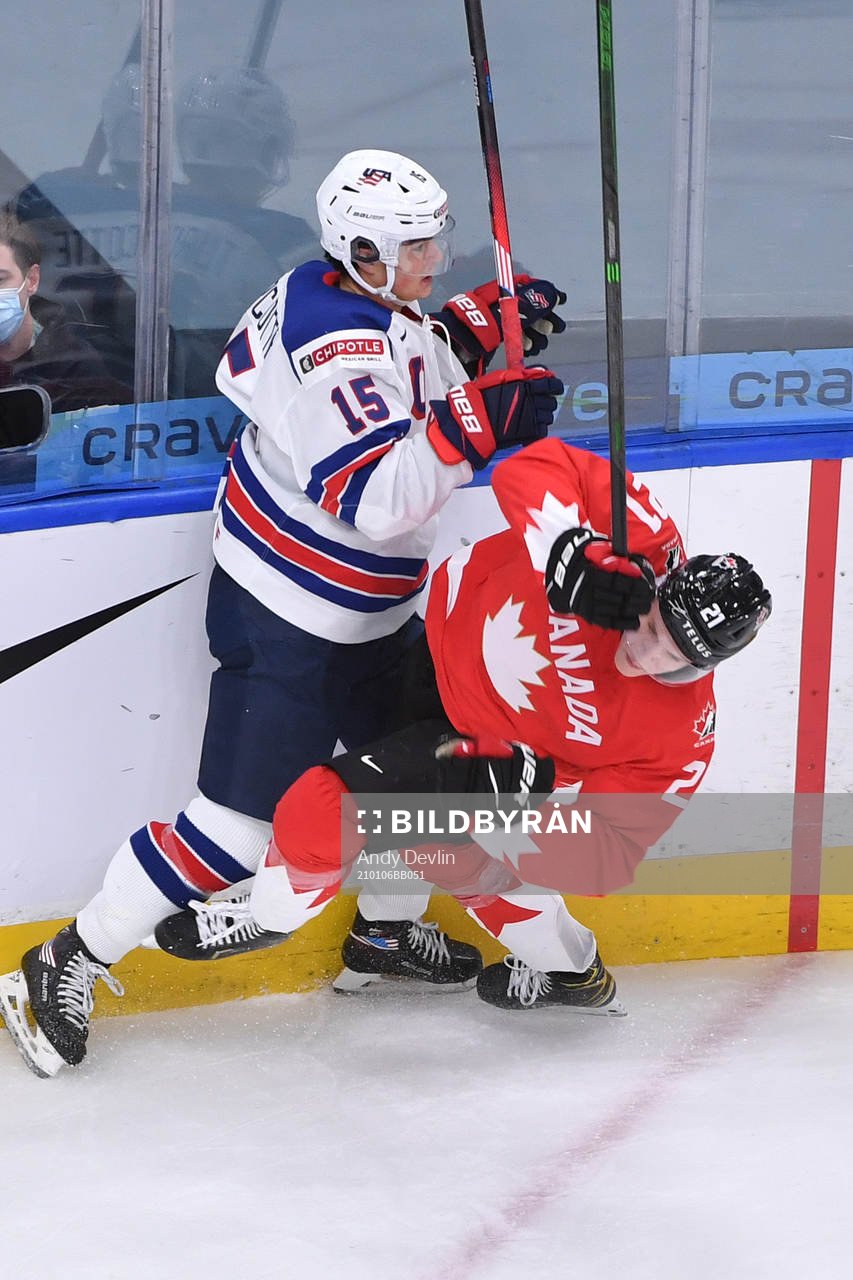 Alex Turcotte of USA knocks down Kaiden Guhle of Canada