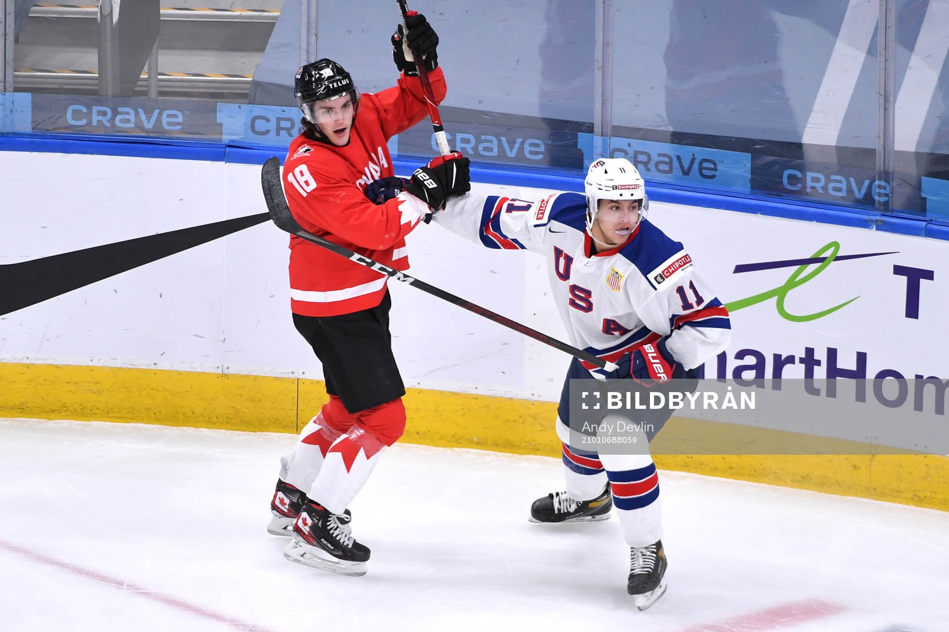 Peyton Krebs of Canada collides with Brock Faber of USA
