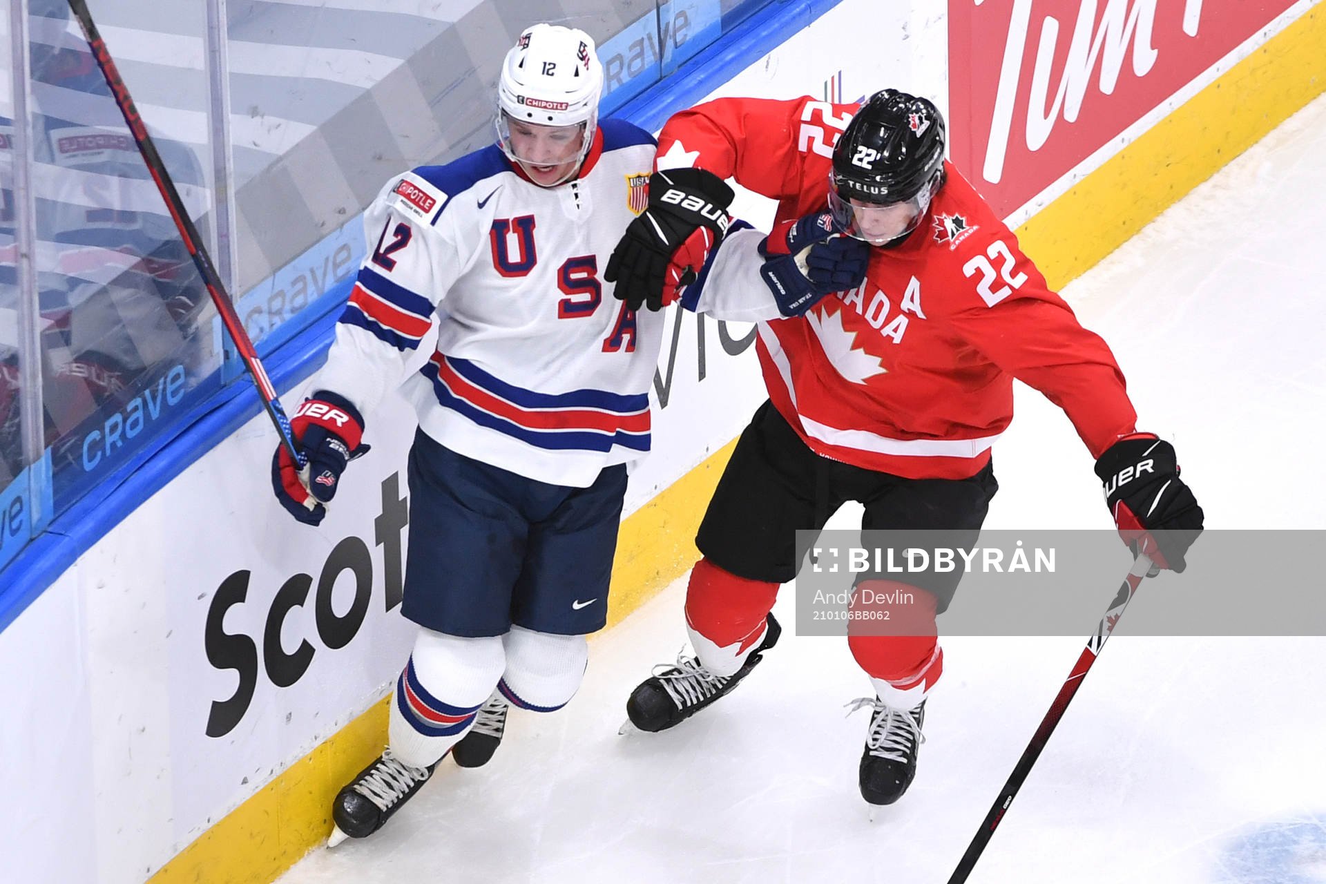 Dylan Cozens of Canada and Matthew Boldy of USA battle for