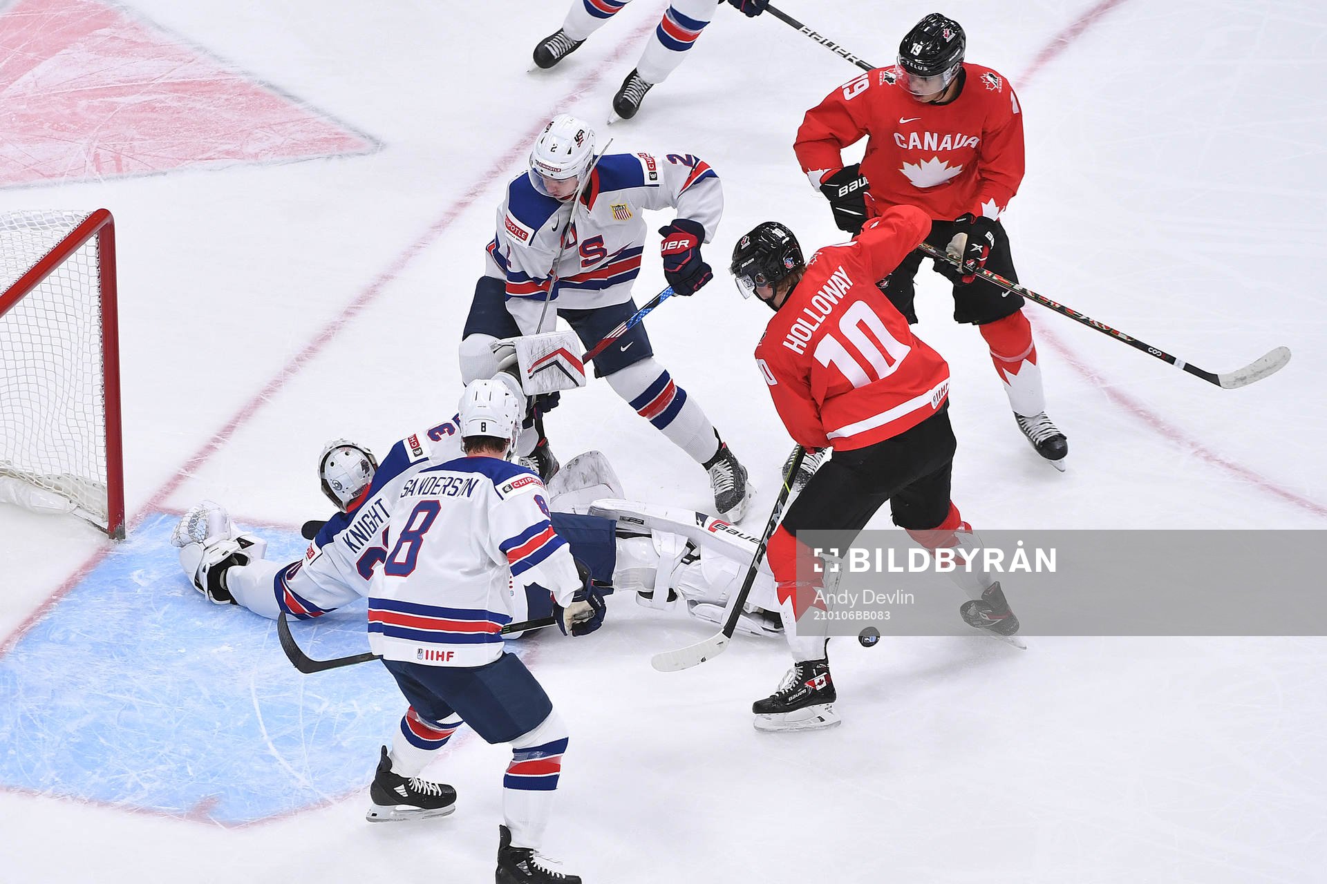 Dylan Holloway and Quinton Byfield of Canada  battle in