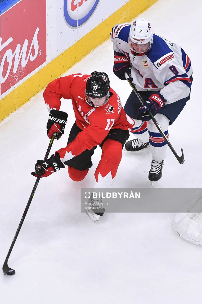 Connor McMichael of Canada keeps the puck away from Jake