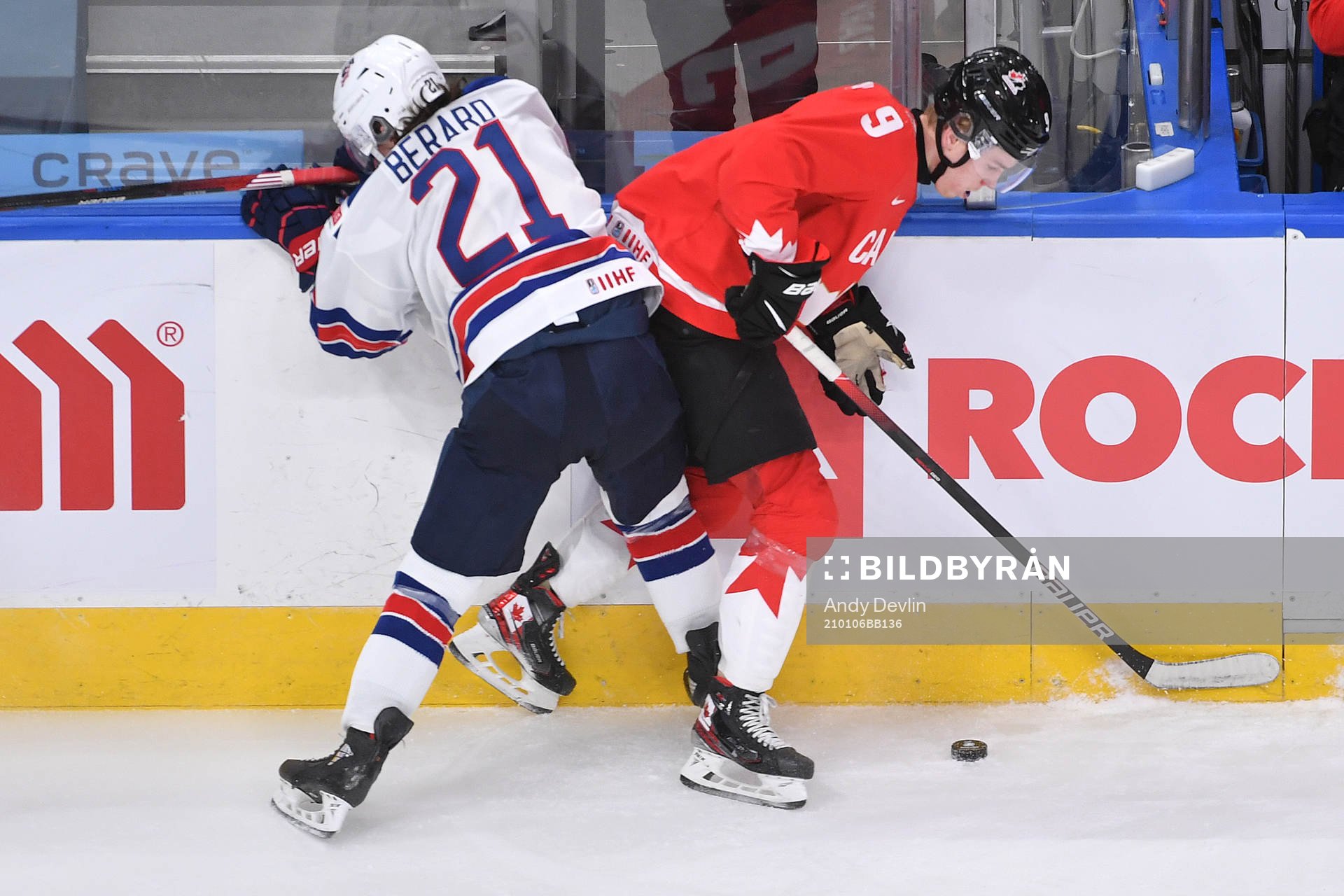 Brett Berard of USA collides with Connor Zary of Canada