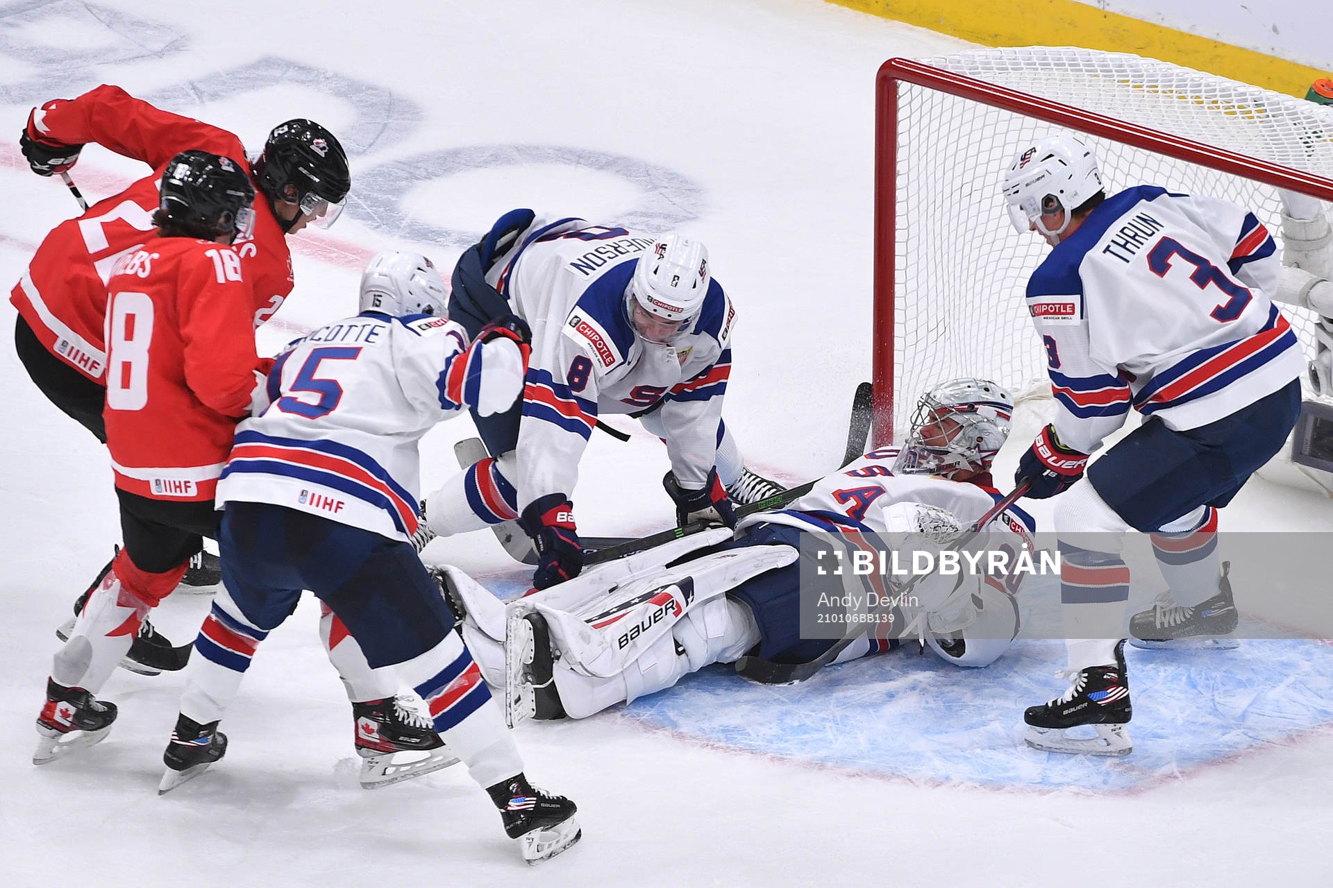 Dylan Cozens and Peyton Krebs of Canada dig at the puck