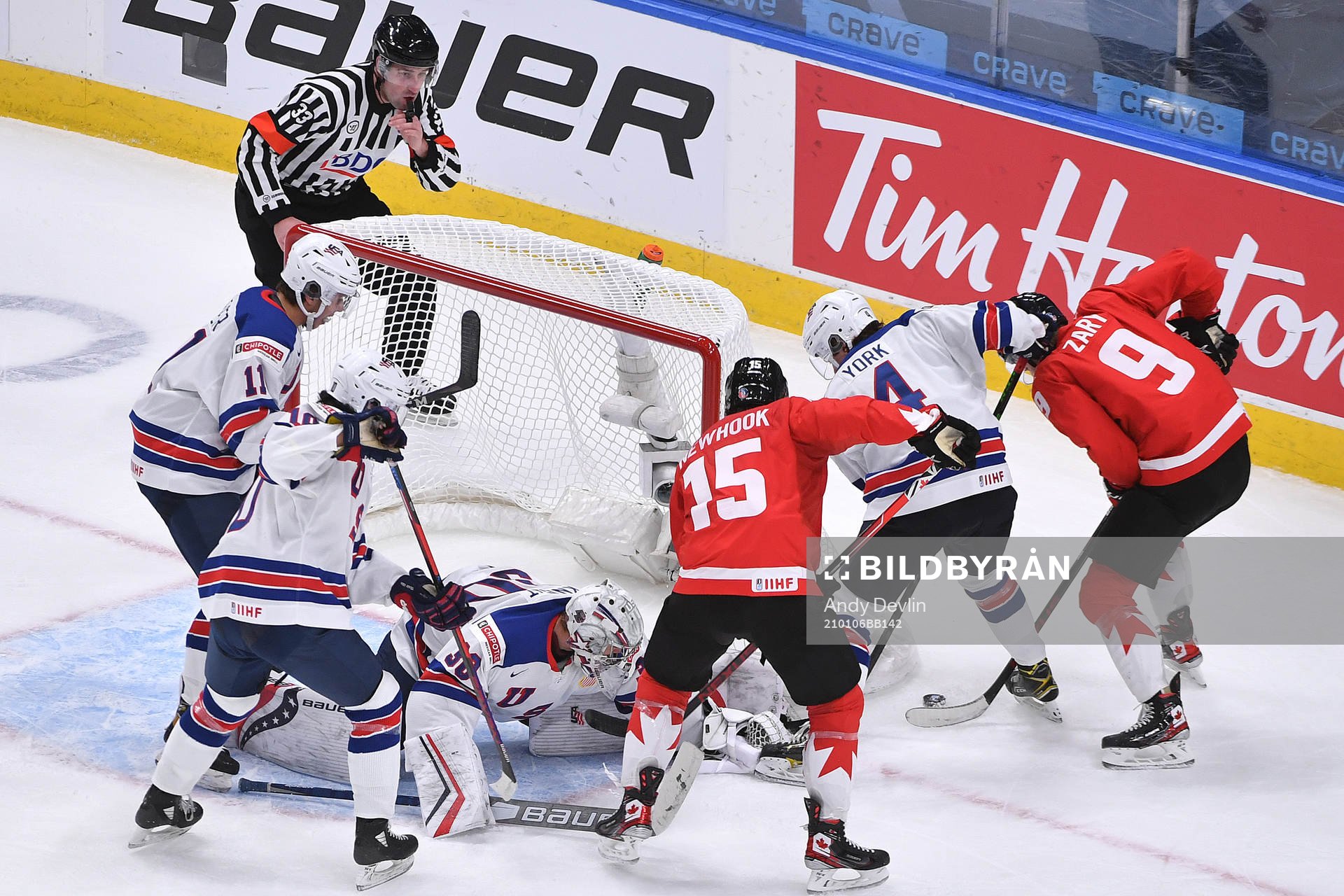 Connor Zary an Alex Newhook of Canada battle with Cam York,