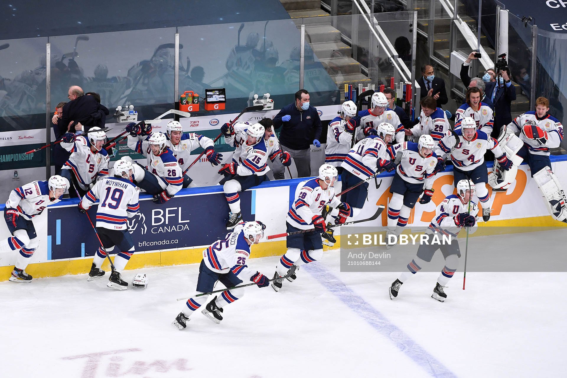 Team USA jumps off their bench to celebrate their victory