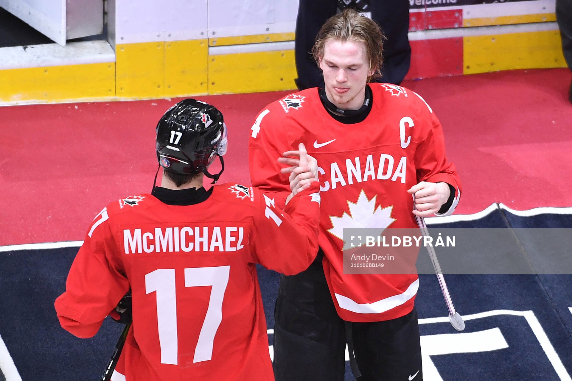 Team Canada captain Bowen Byram presents teammate Connor