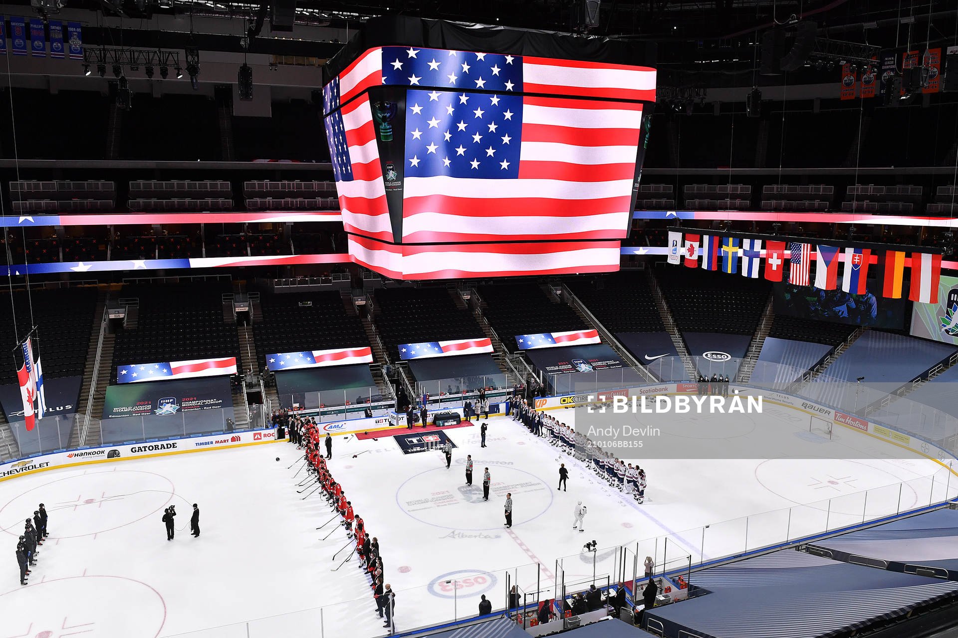 Team Canada and Team USA stand for the USA national anthem