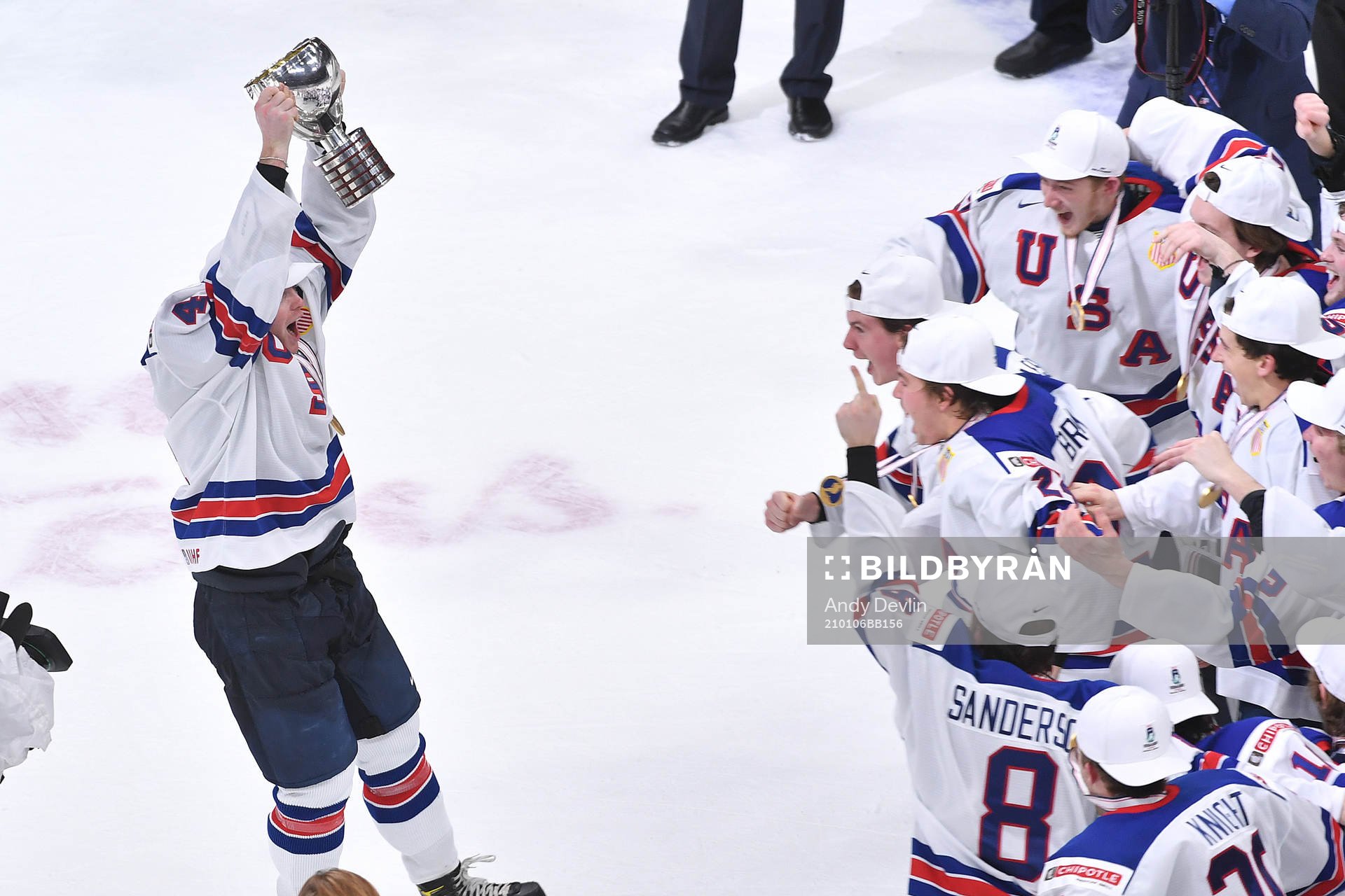 Cam York of USA brings the world junior championship trophy