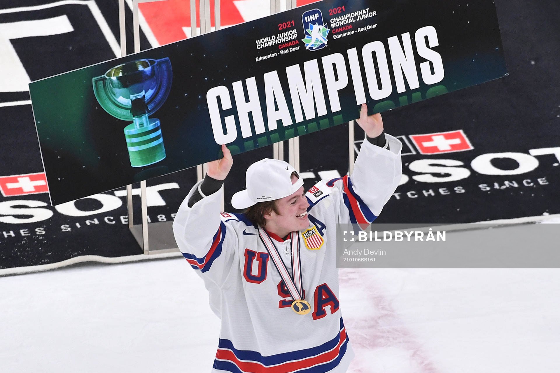 Cole Caufield of USA holds up championship sign