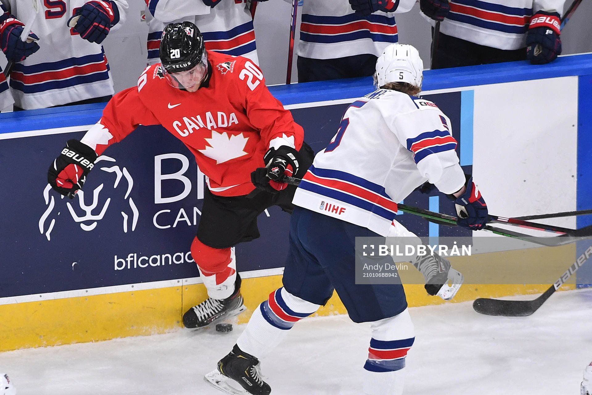 Jackson LaCombe of USA collides with Dawson Mercer of Canada