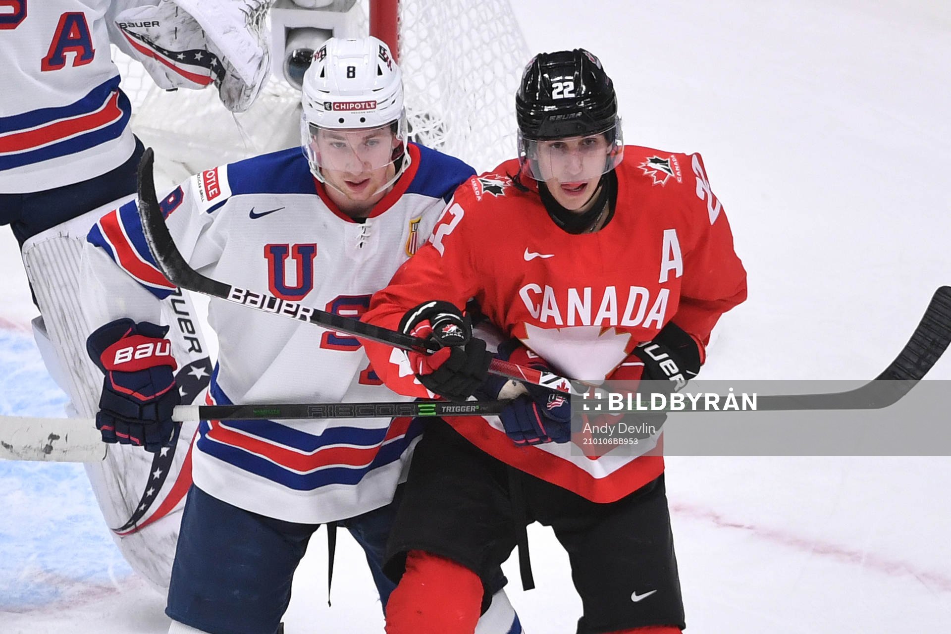 Dylan Cozens of Canada and Jake Sanderson of USA battle for