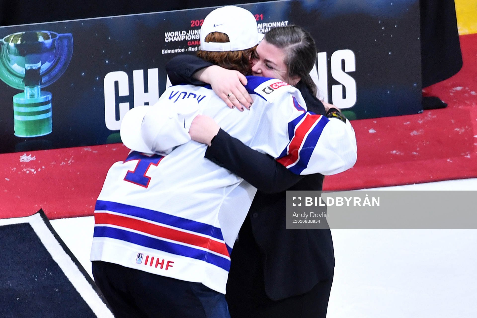 Team USA captain Cam York hugs video coach Theresa Feaster,