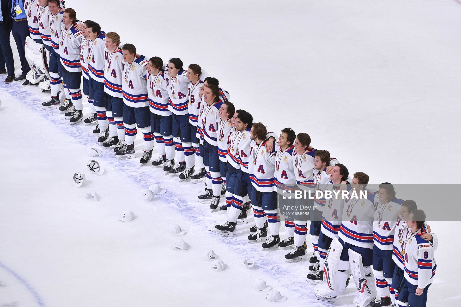 Team USA stands arm in arm singing their national anthem