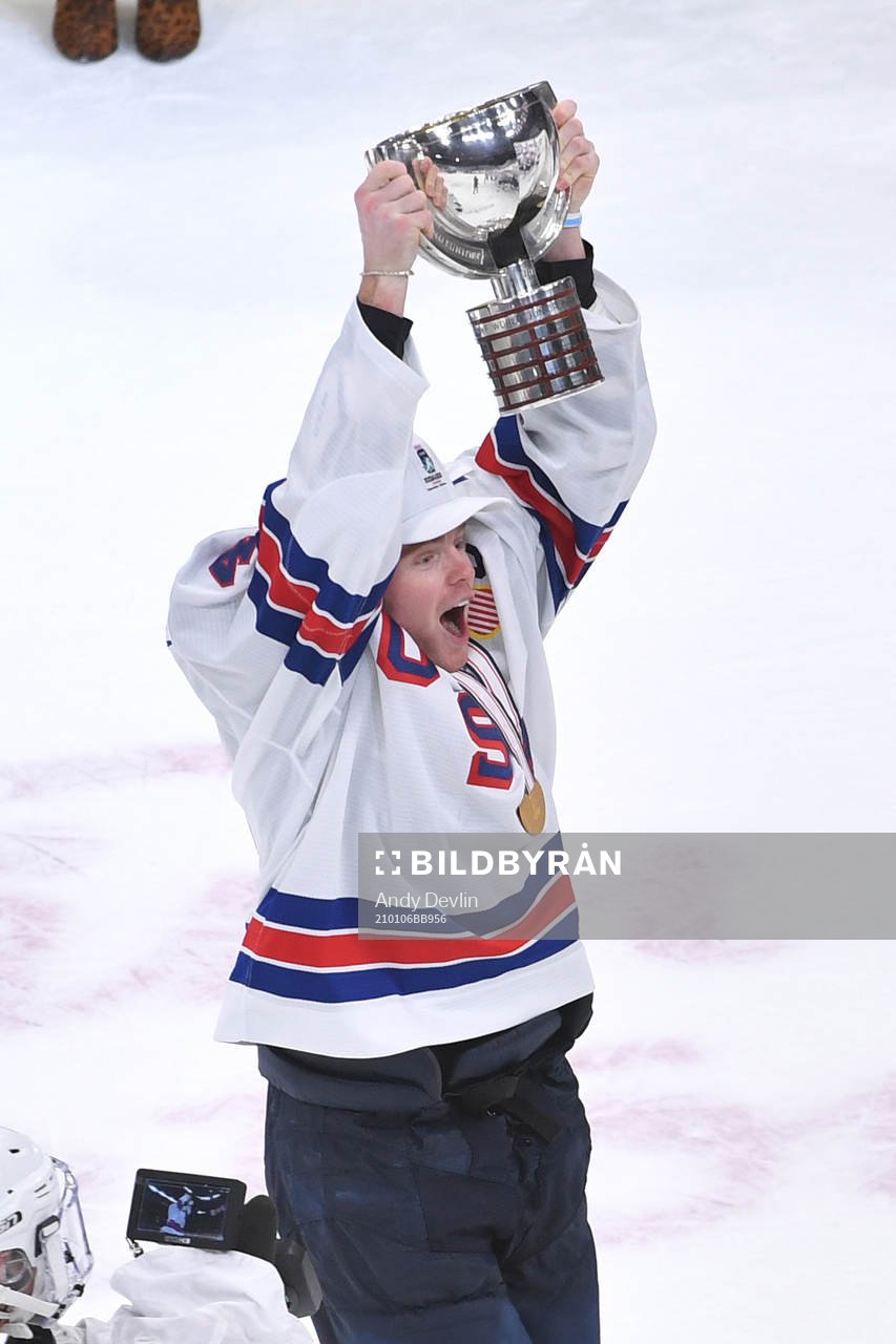 Cam York of USA hoists the first place trophy