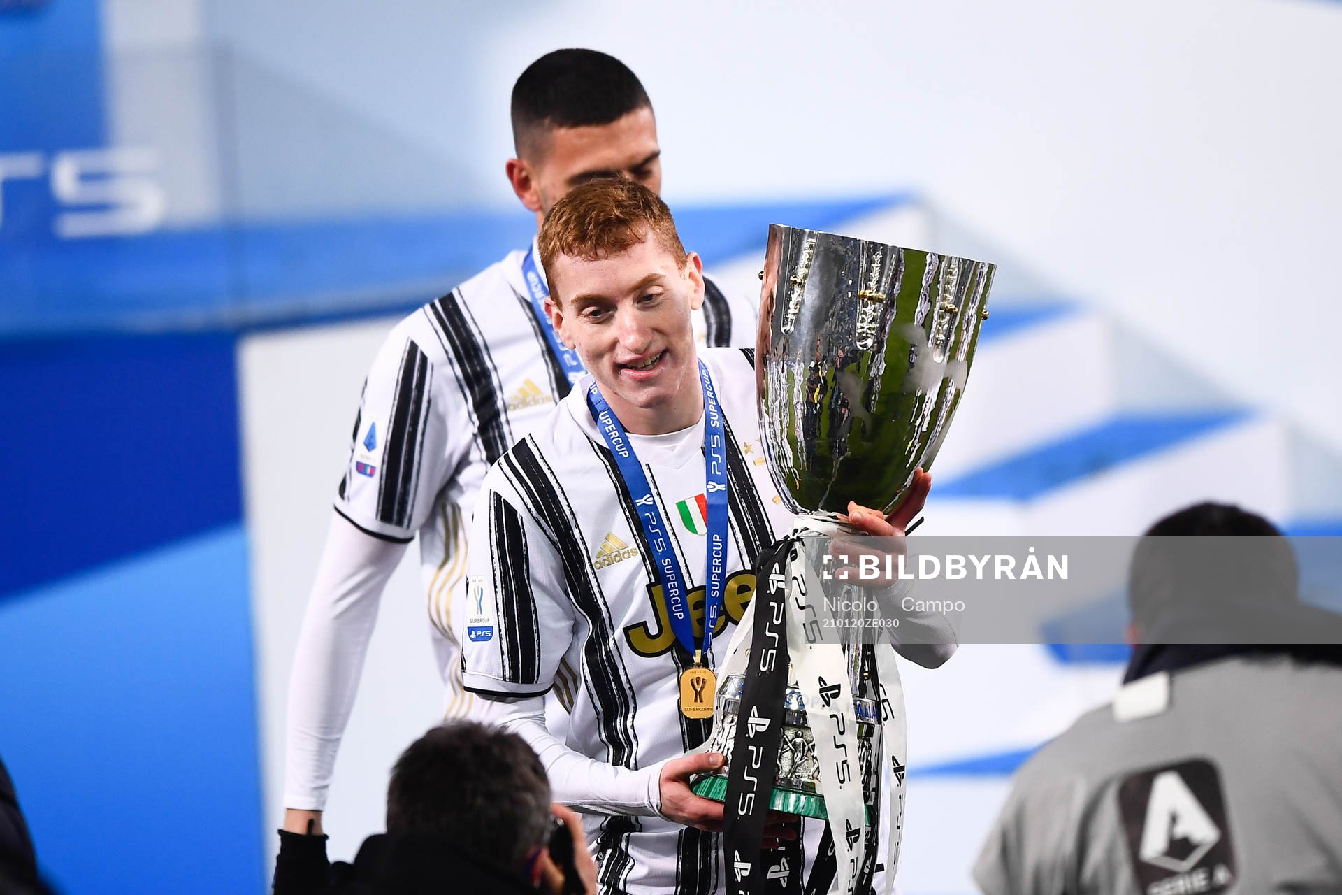 Dejan Kulusevski of Juventus celebrates with the trophy