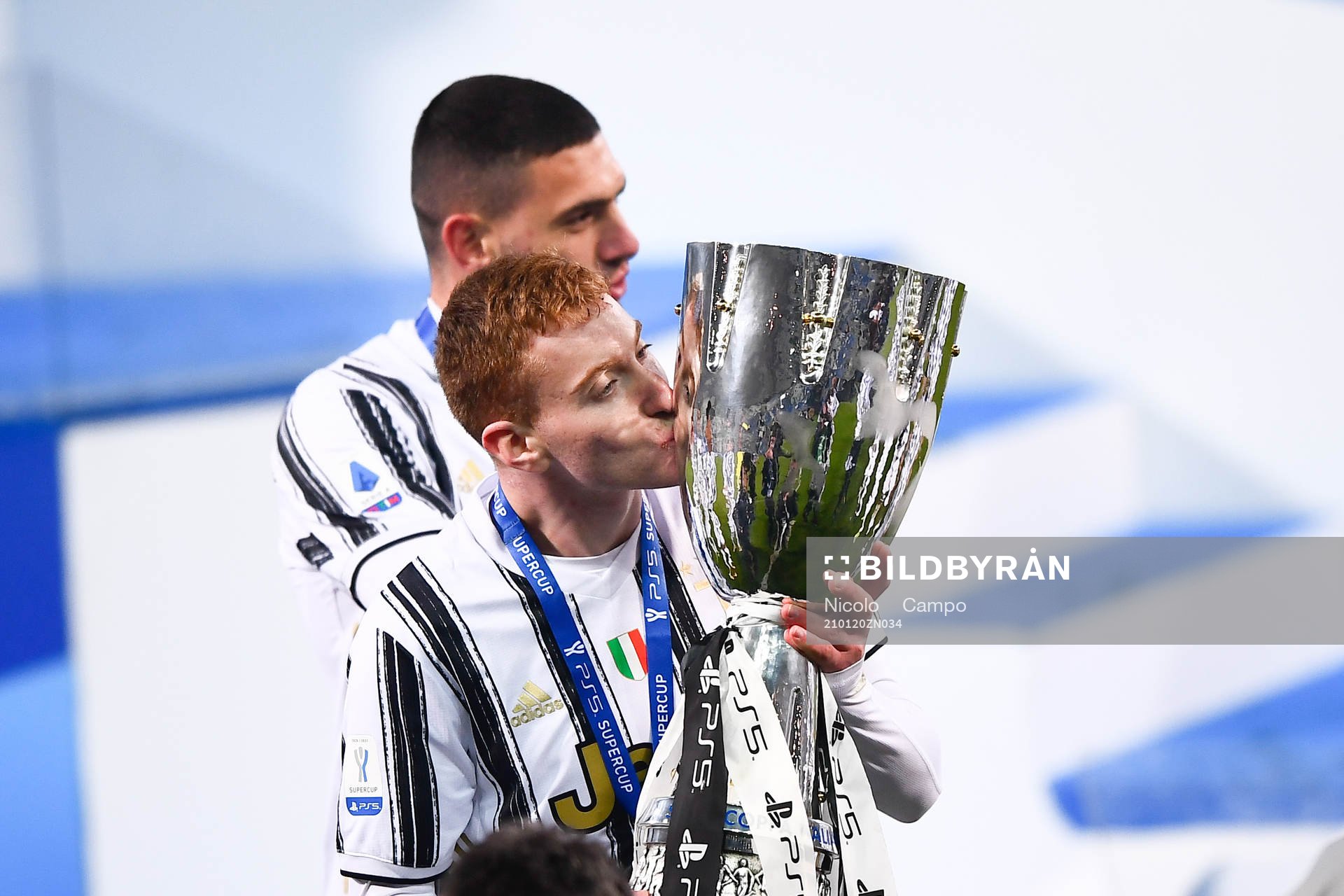 Dejan Kulusevski of Juventus celebrates with the trophy